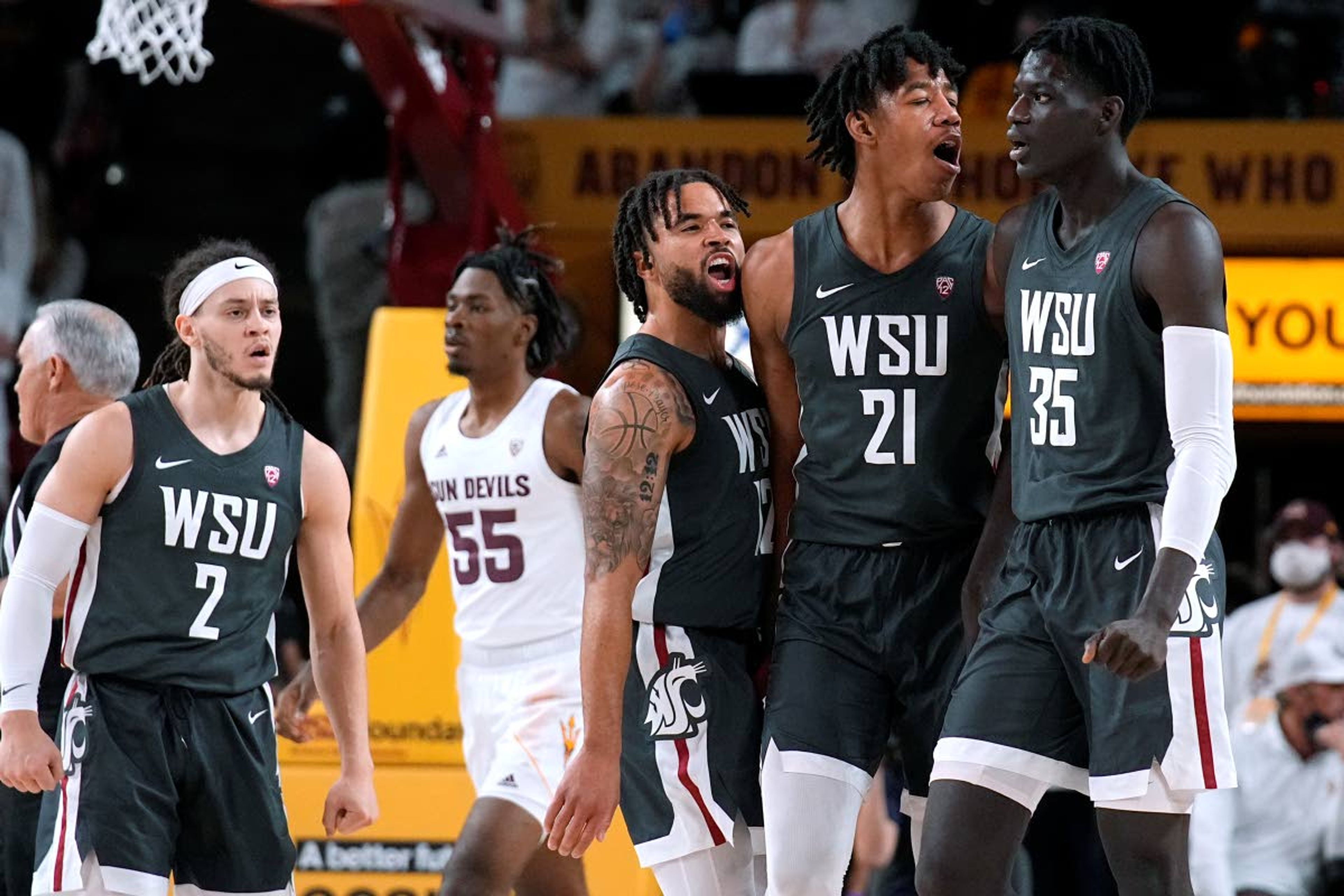 Washington State forward Mouhamed Gueye (35) celebrates with, from left, guard Tyrell Roberts, guard Michael Flowers and post Dishon Jackson after scoring against Arizona State in the second half of Wednesday’s game in Tempe, Ariz. WSU won easily, 51-29.