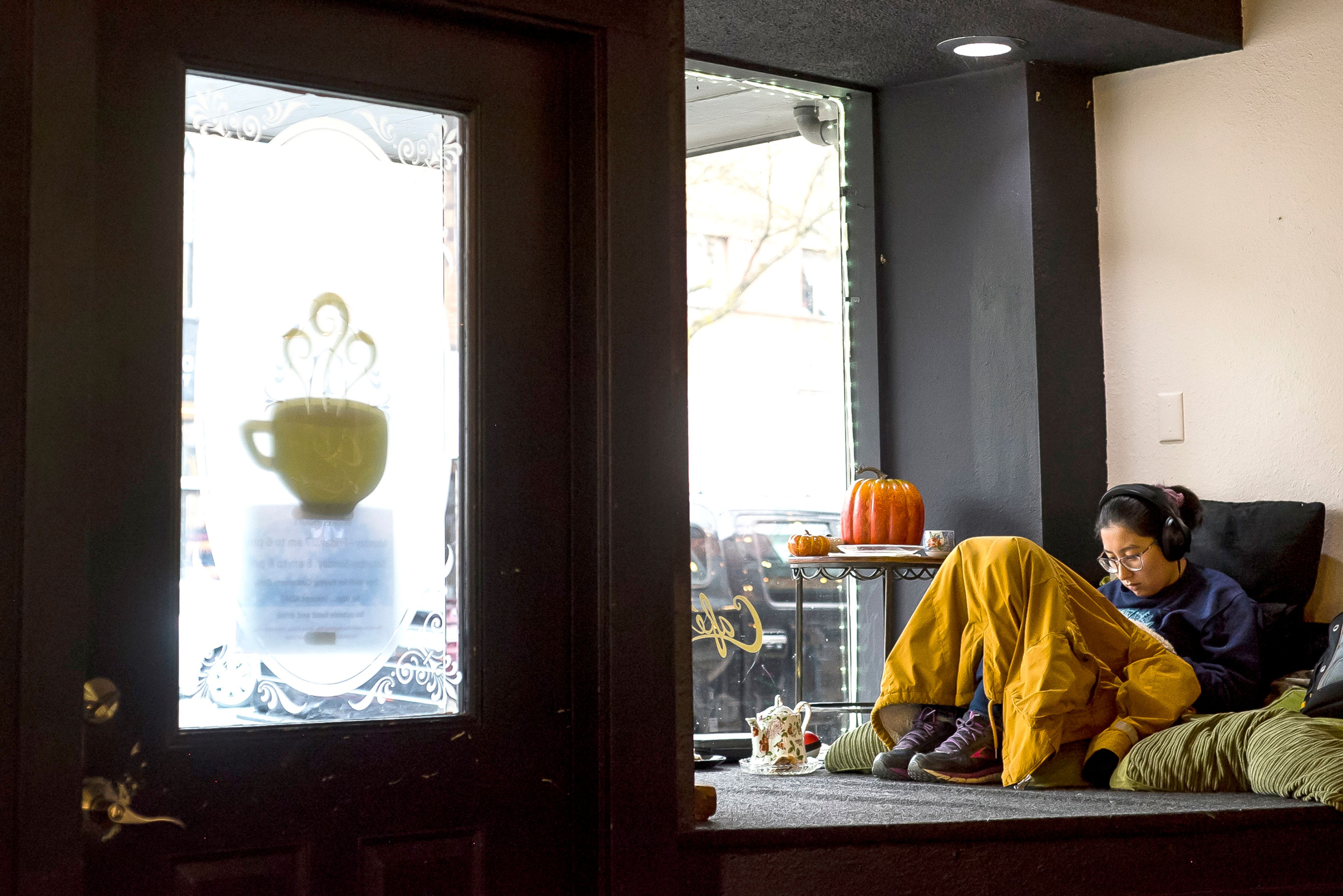 Christine Page, an electrical engineering student at the University of Idaho, relaxes after class in a window nook at CafŽ Artista on Nov. 15 in Moscow.