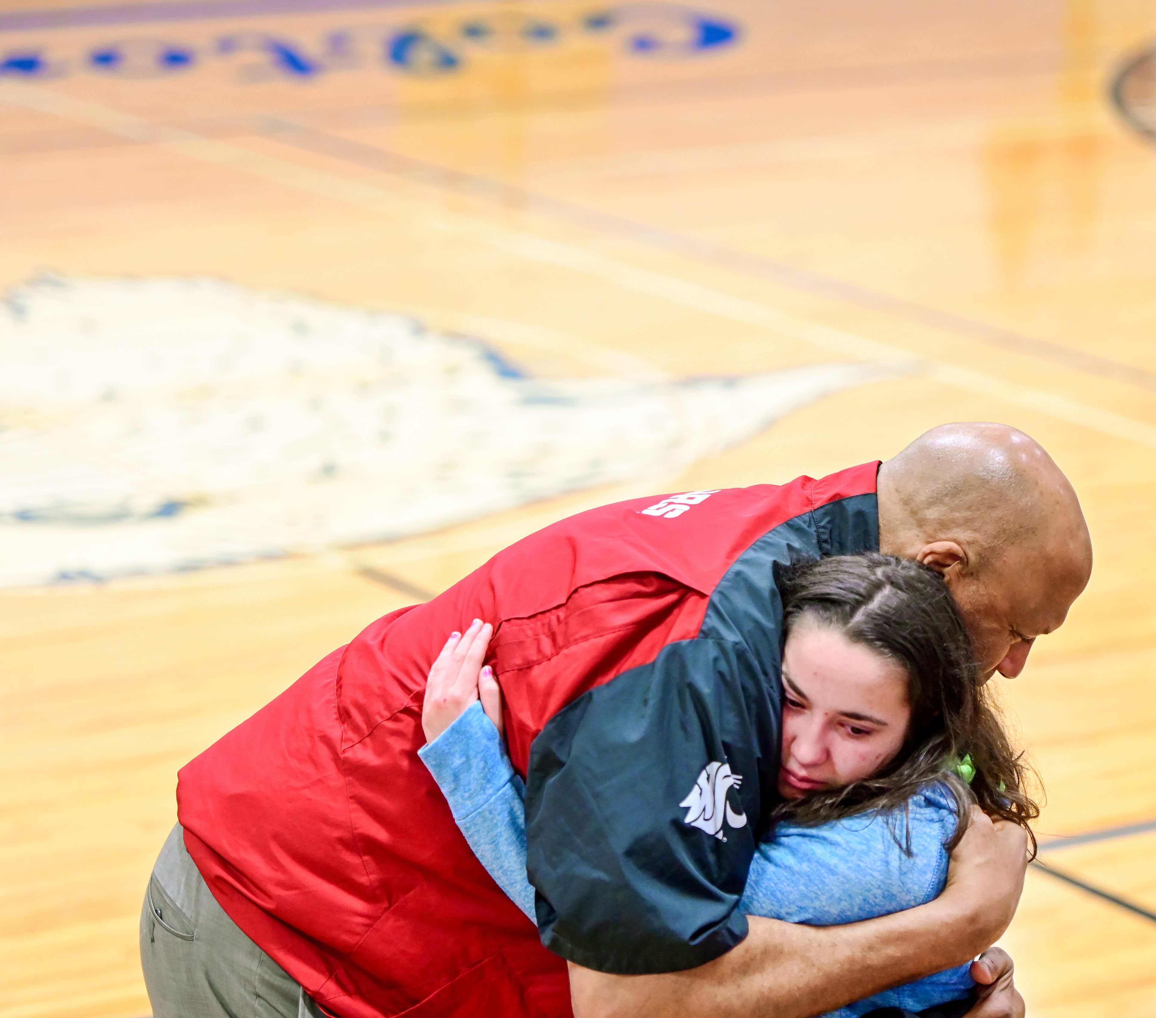 Former NBA and WSU athlete James Donaldson and Isis Luke, a junior at Colton High School, share an embrace after Donaldson’s talk about mental health with students on Tuesday.