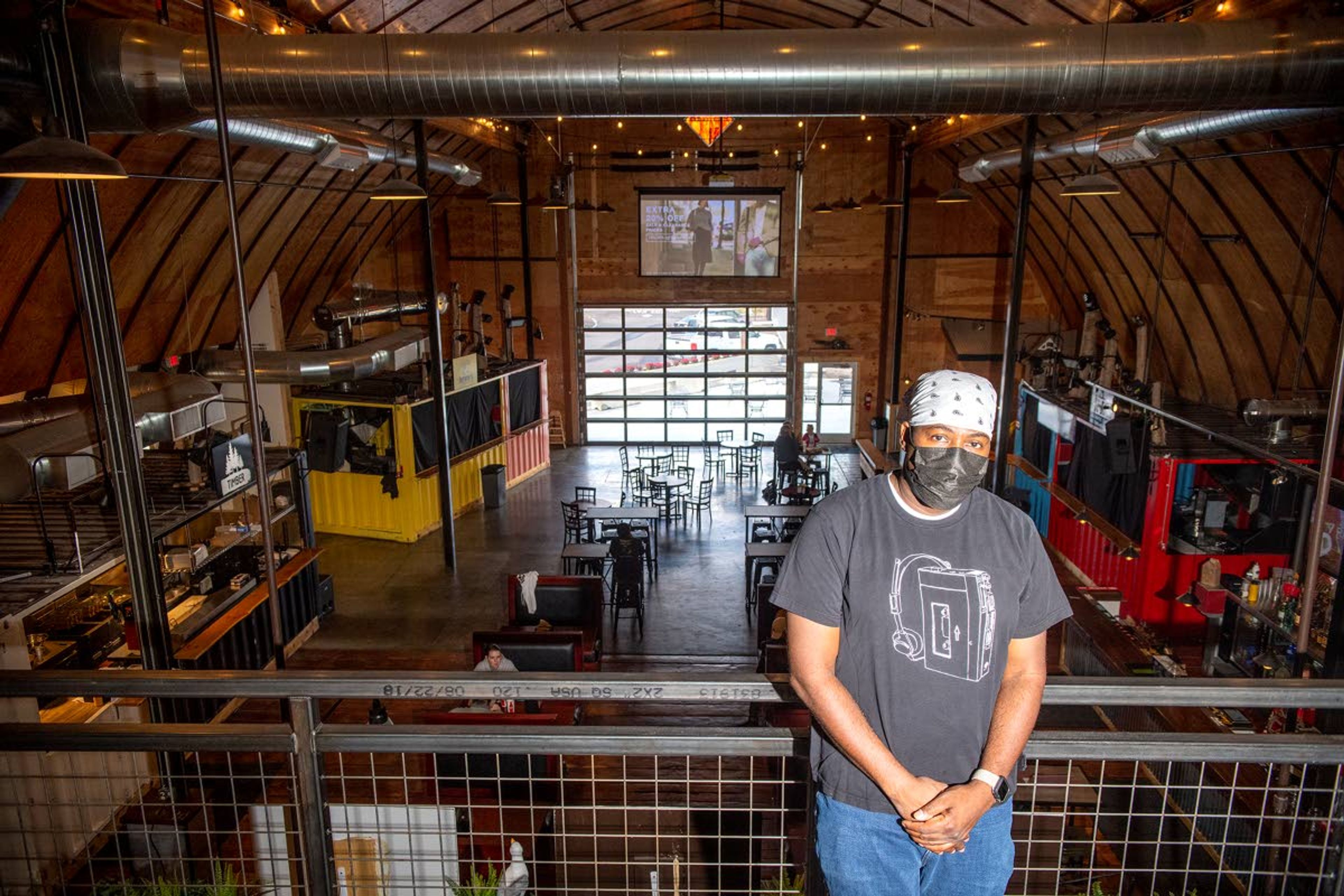 DJ Goldfinger, co-owner of Lumberyard in Pullman, poses for a portrait on the second floor of the building where Top Shelf bar is located. Lumberyard currently hosts two food vendors with two more on the way in addition to two bars and an Airbnb.