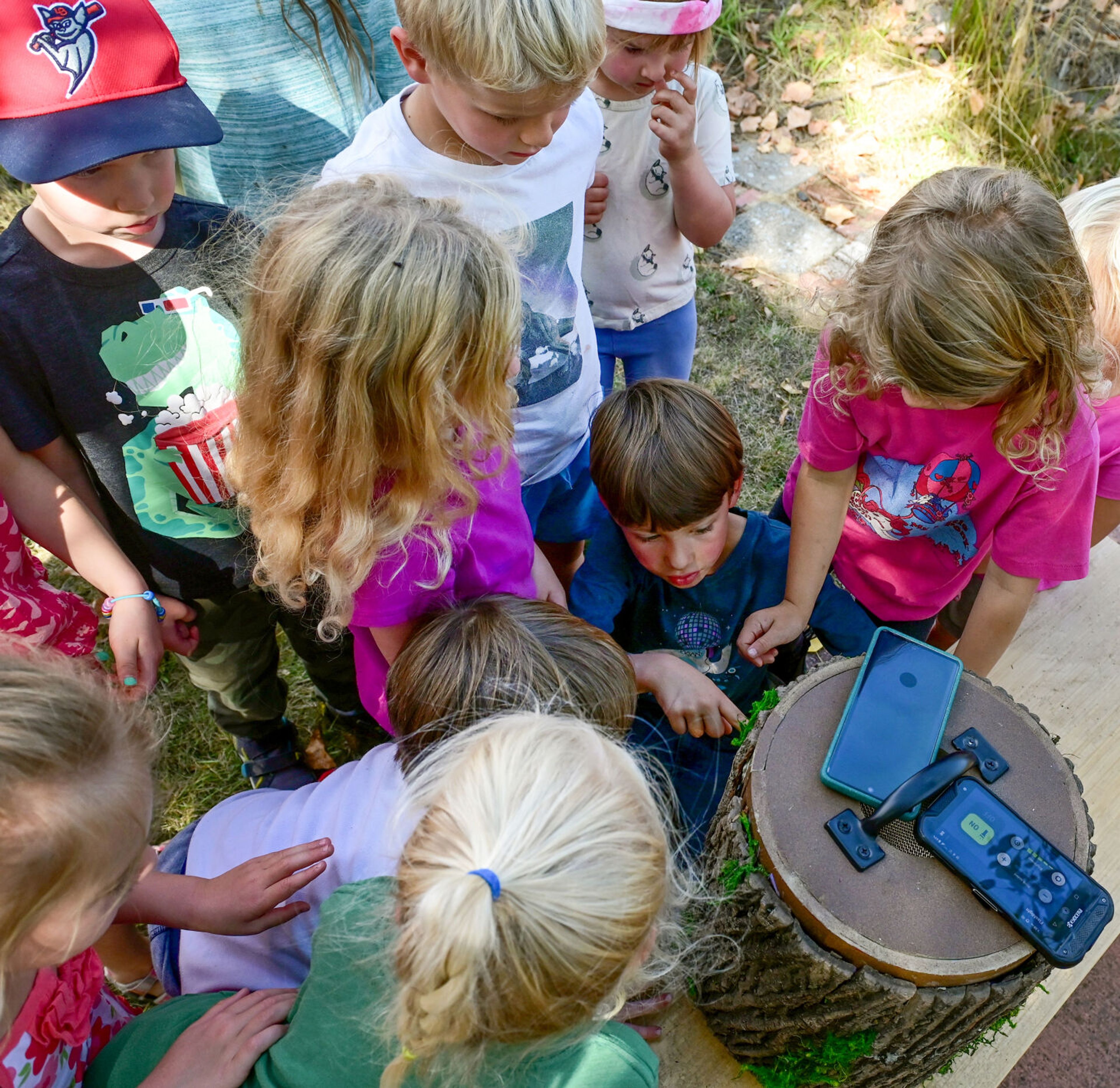 Students of Palouse Roots, Palouse-Clearwater Environmental Institute’s nature school, gather around a carrier for Hurik, a Northern pygmy owl, from Washington State University at the nature center Thursday in Moscow.