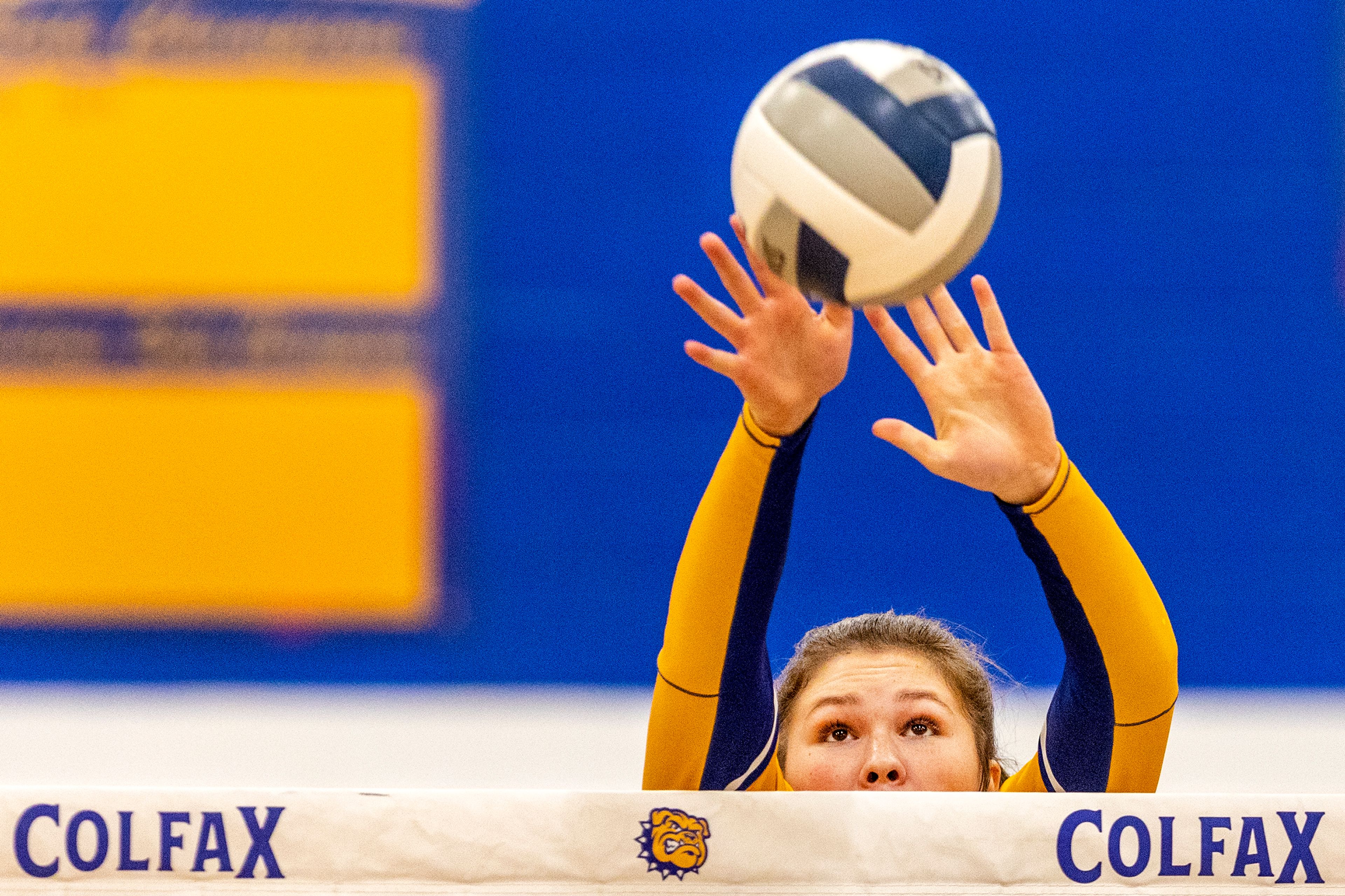 Colfax middle hitter Brynn McGaughy blocks the ball against St. George's at Colfax on Tuesday.