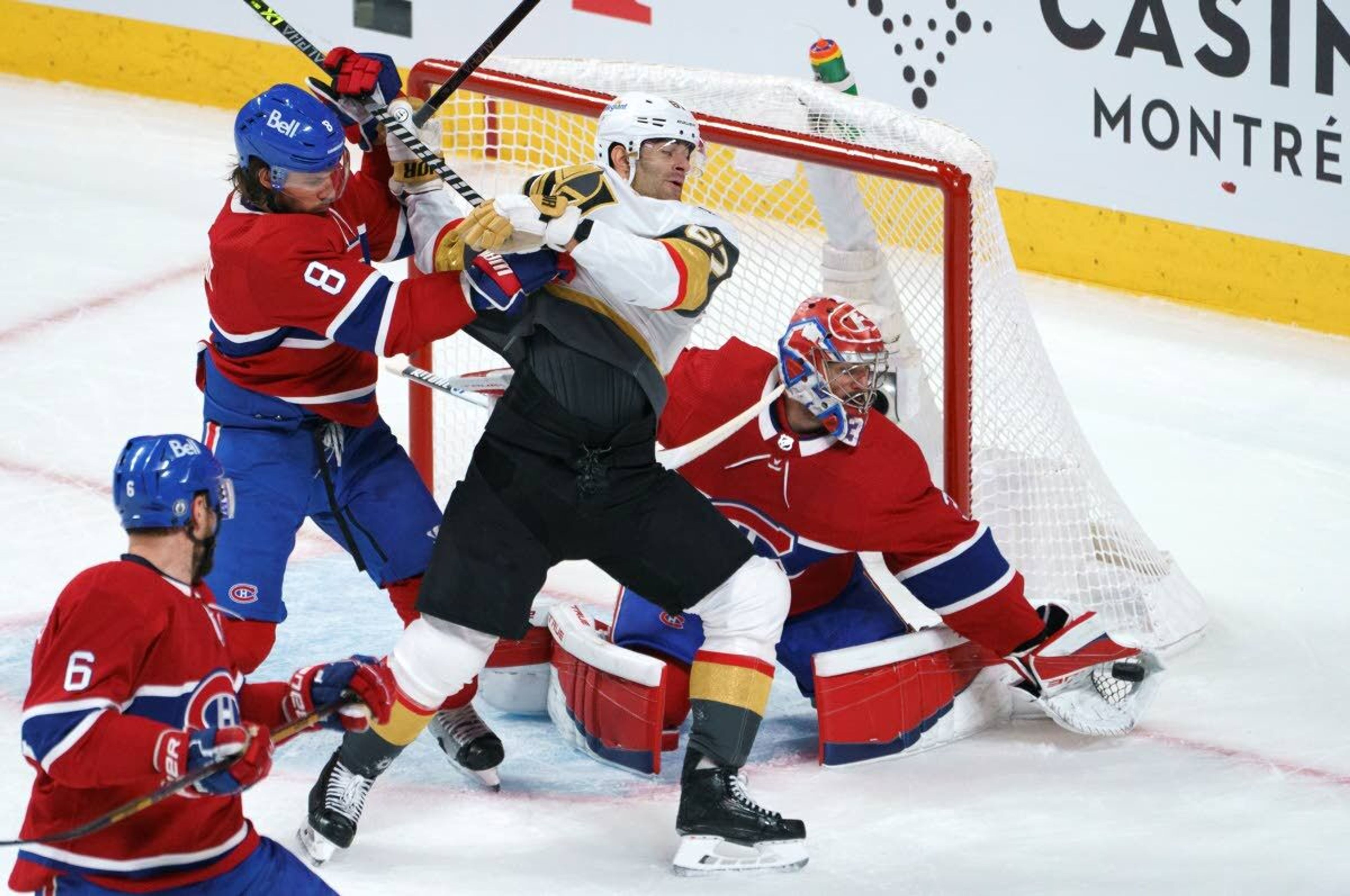 Vegas Golden Knights' Max Pacioretty is taken out by Montreal Canadiens defenseman Ben Chiarot as goaltender Carey Price snags the puck during the first period of Game 4 in an NHL Stanley Cup playoff hockey semifinal in Montreal, Sunday, June 20, 2021.