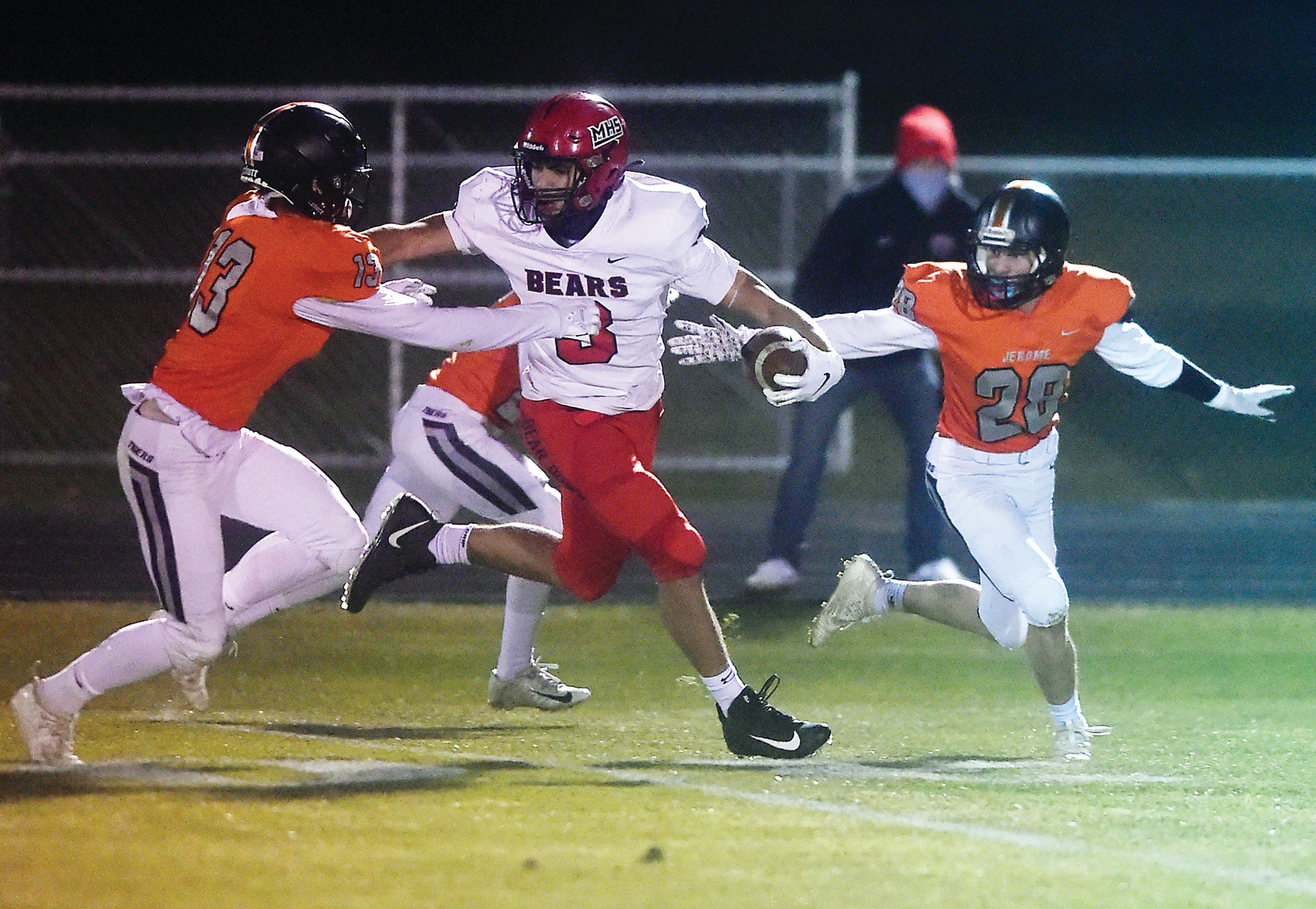 Moscow's Jonah Elliss stiff-arms Jerome's Nate McDonald (left) as Matt Hess (right) comes from behind during their Class 4A first-round state football playoff game on Oct. 30, 2020.