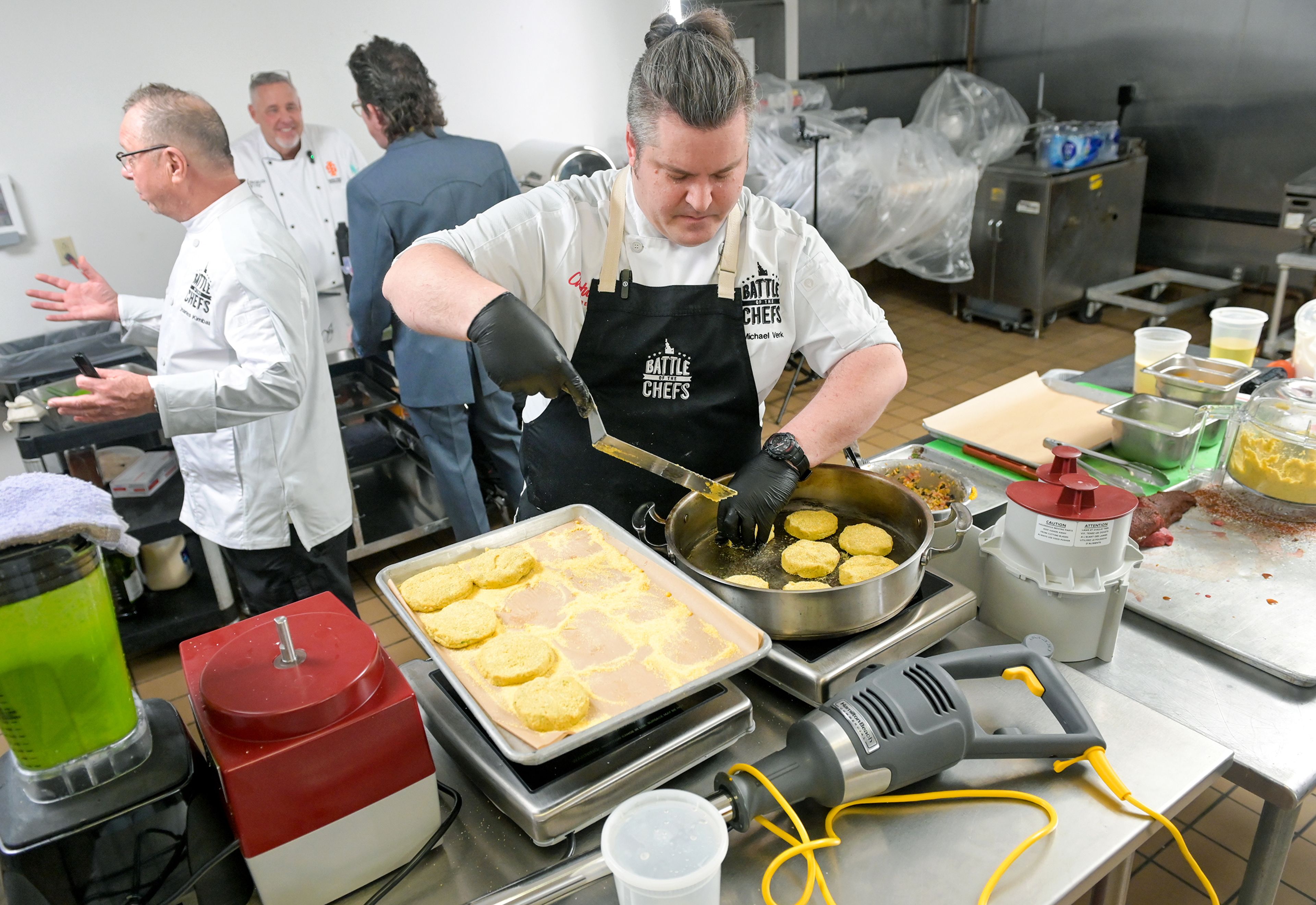 Chef Michael Verk, right, an executive chef with the University of Idaho’s Idaho Eats, works to prepare a dish for the Battle of the Chefs Wednesday in the kitchen at The Eatery on campus in Moscow. Verk went on to win the competition.