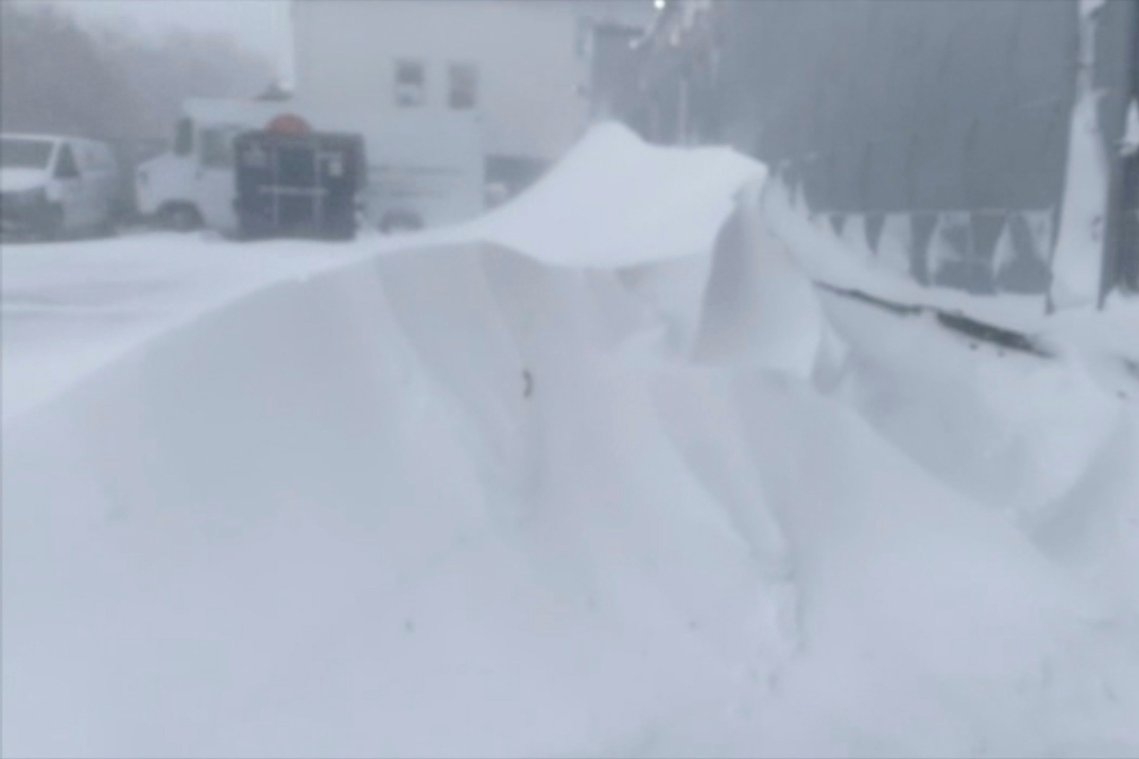 High winds and snow covers the streets and vehicles in Buffalo, N.Y. on Sunday, Dec. 25, 2022. Millions of people hunkered down in a deep freeze overnight and early morning to ride out the frigid storm that has killed at least 20 people across the United States, trapping some residents inside homes with heaping snow drifts and knocking out power to several hundred thousand homes and businesses.(WKBW via AP)