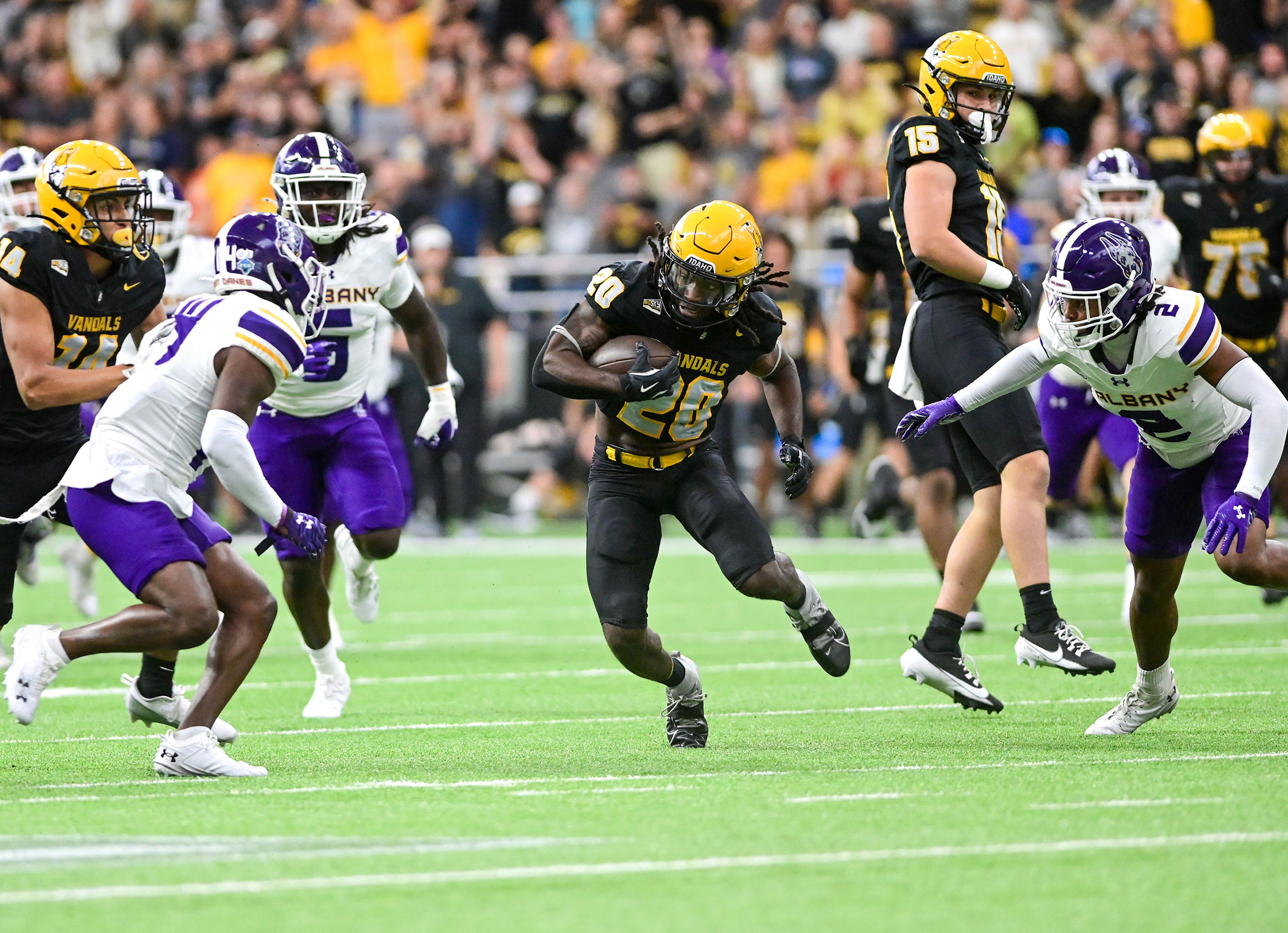 Idaho Vandals running back Elisha Cummings (20) dodges Albany Great Danes defenders Sept. 14 at the P1FCU Kibbie Dome in Moscow.