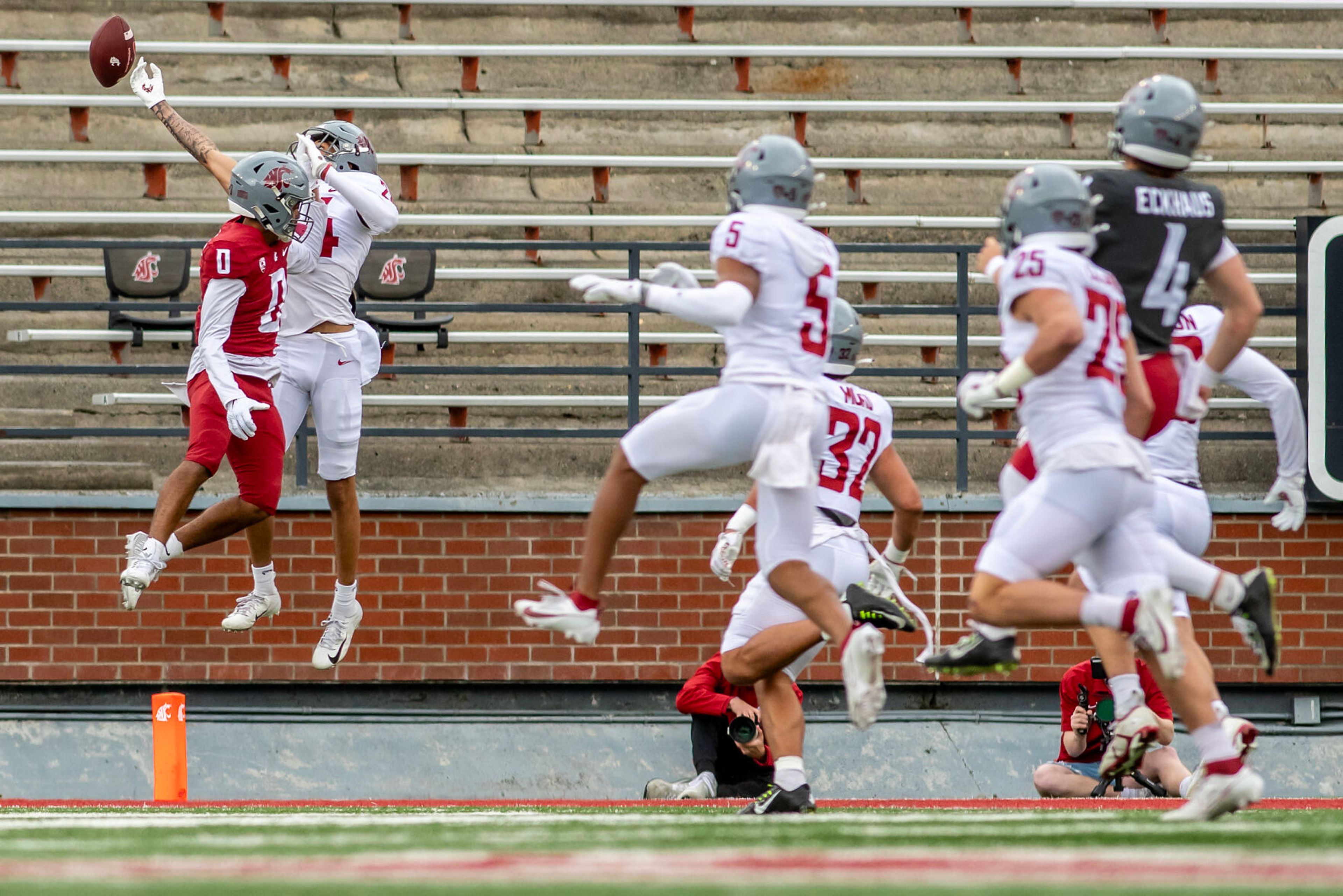 Crimson wide receiver Tony Freeman competes with Gray defensive back Ethan O’Connor for a catch in a quarter of the Crimson and Gray Game at Washington State University in Pullman.