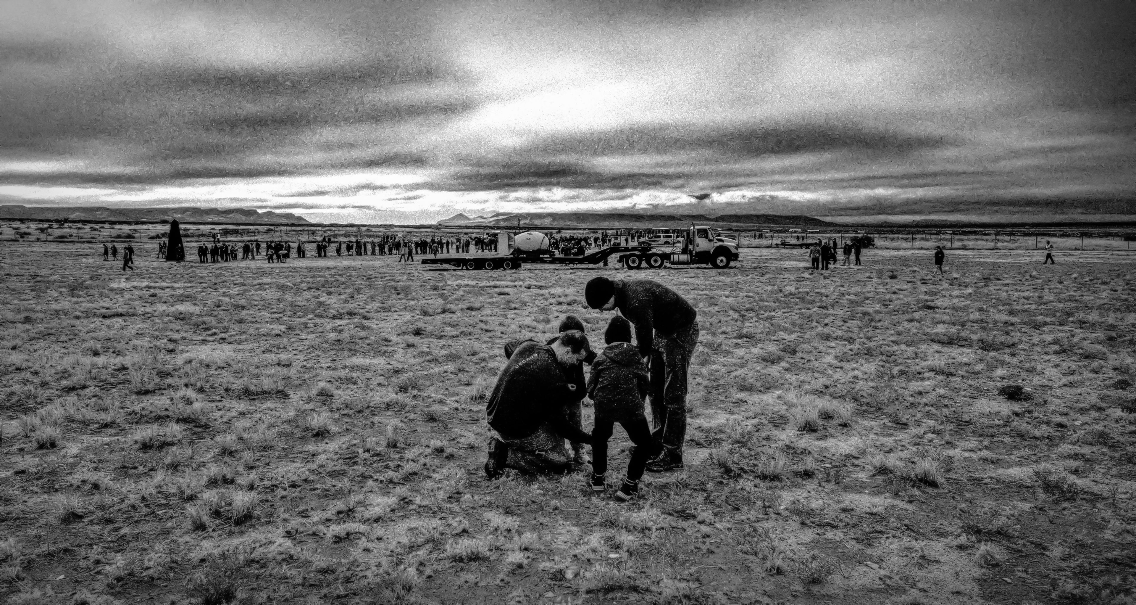 A family searches the ground around ground zero for pieces of Trinitite, the green glass created from the nuclear explosion.�Taking the pieces home is not allowed.,