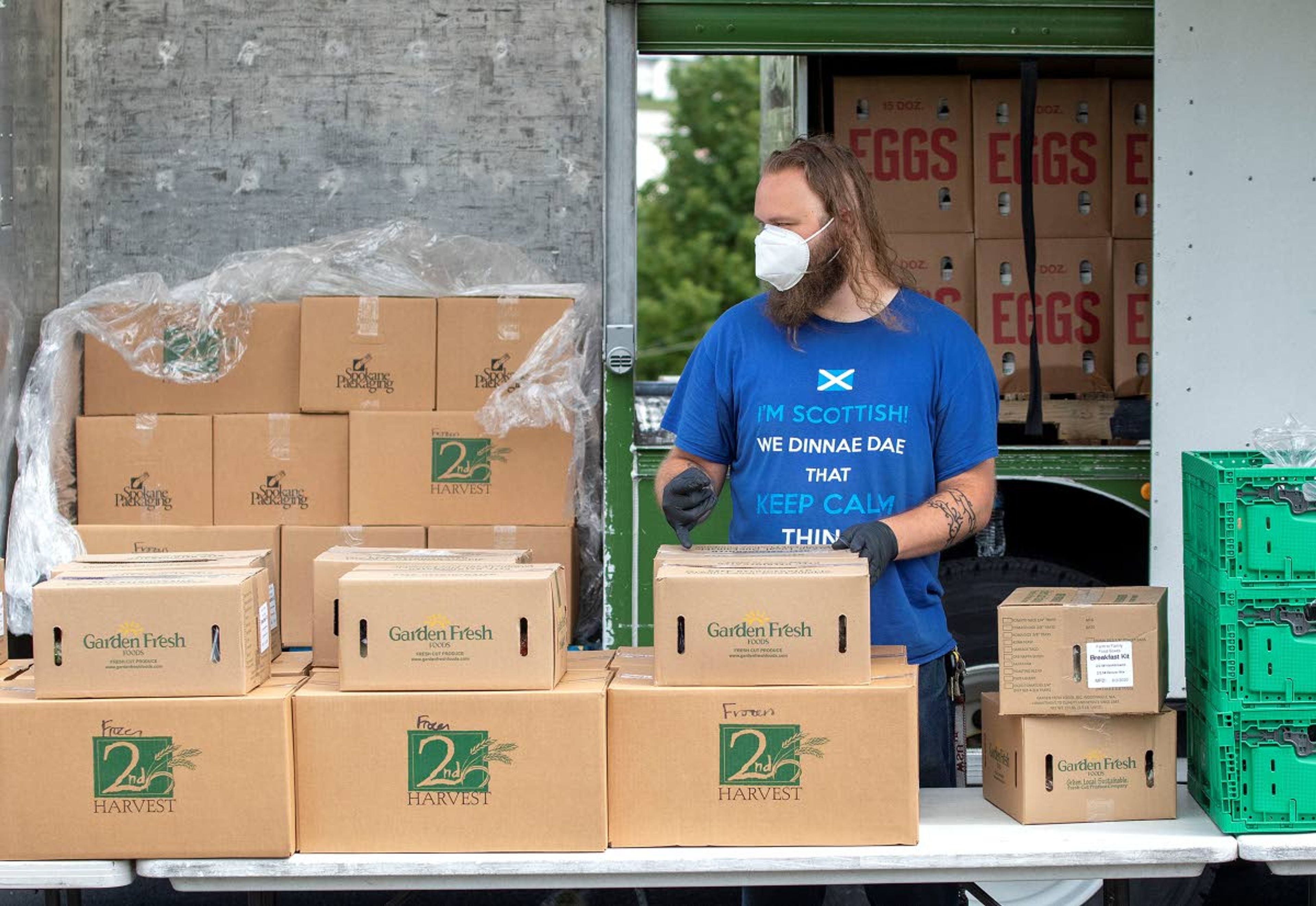 Karl Howell stacks boxes of food during a free food distribution on Wednesday at Trinity Lutheran Church in Pullman. The event was organized by the church in cooperation with 2nd Harvest from Spokane.