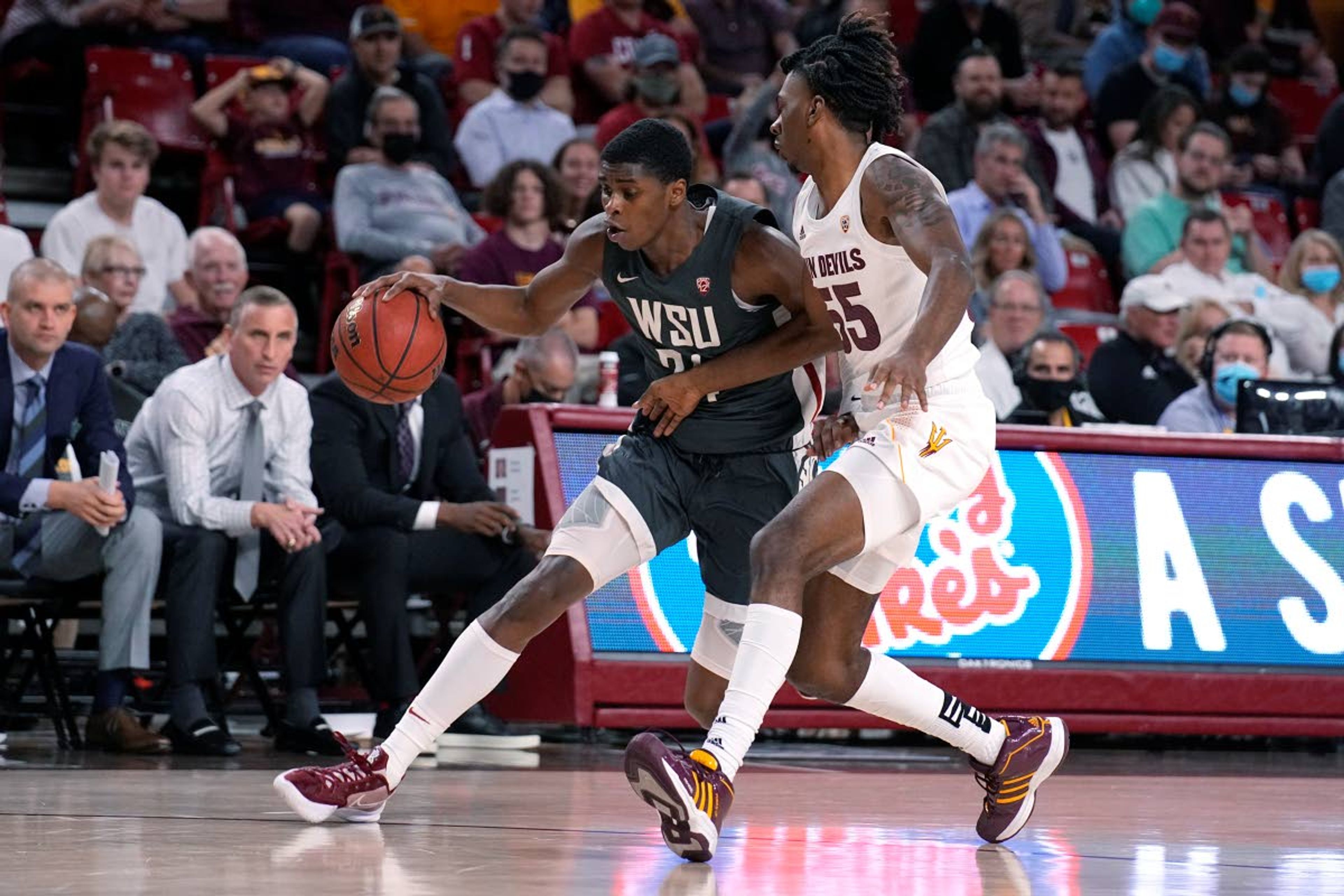 Associated PressWashington State guard Noah Williams drives past Arizona State forward Jamiya Neal during the first half. Williams scored 14 points.