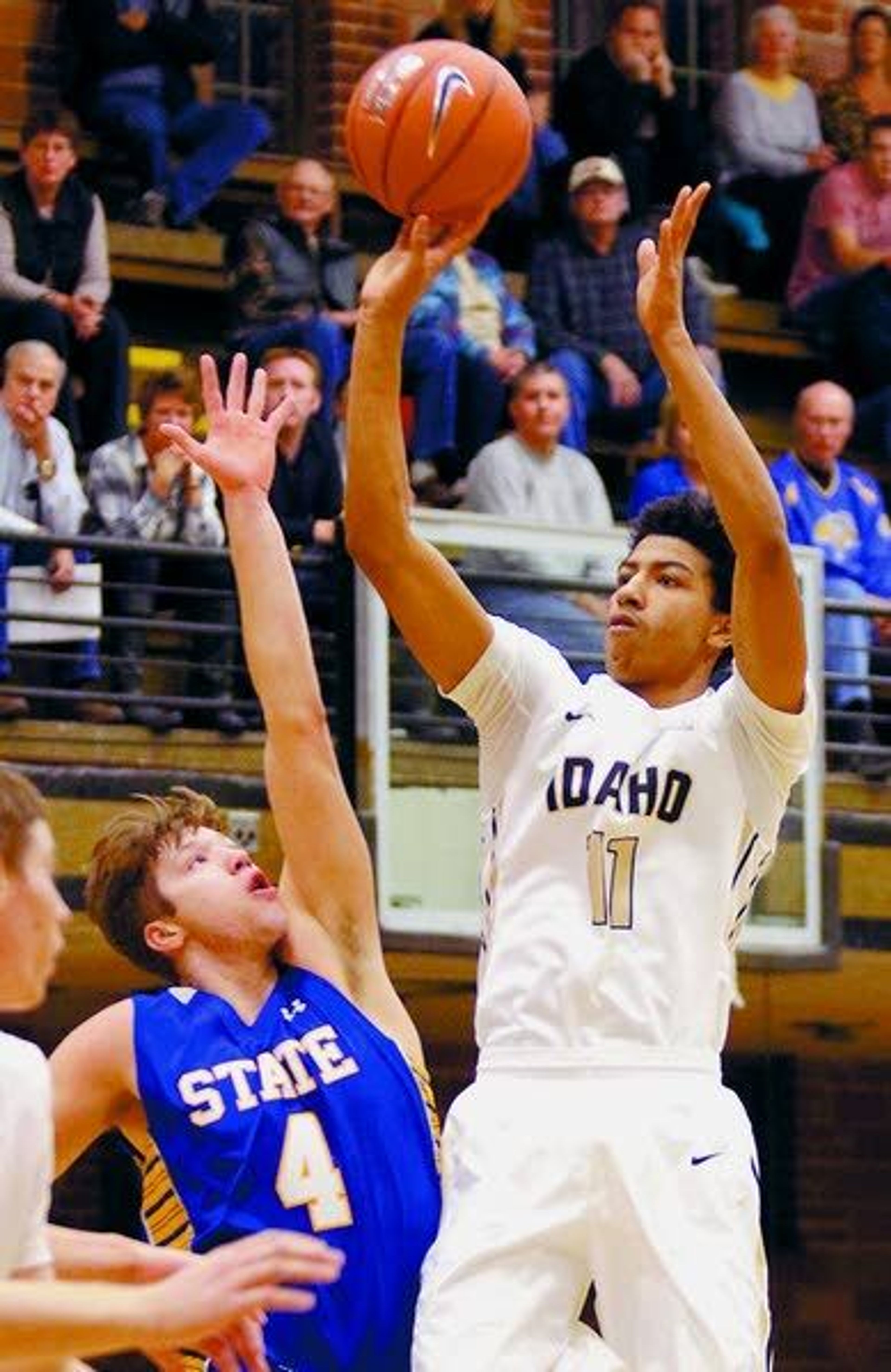 Idaho guard Victor Sanders, right, puts up a shot under pressure from South Dakota State’s Jake Bittle in the first half Monday at Memorial Gymnasium in Moscow.