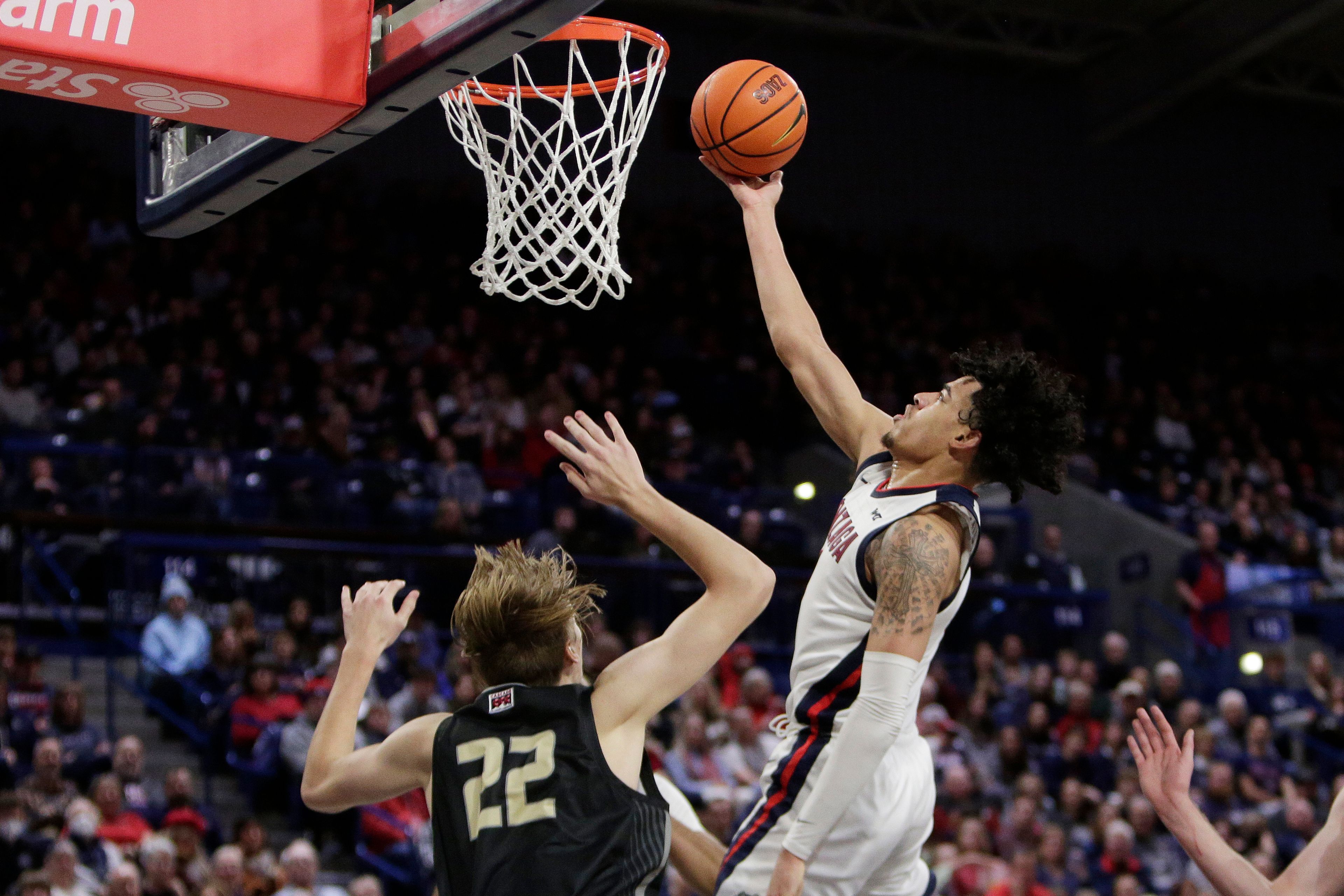 Gonzaga guard Julian Strawther, right, shoots while defended by Eastern Oregon forward Riley O'Harra during the second half of an NCAA college basketball game Wednesday, Dec. 28, 2022, in Spokane, Wash. Gonzaga won 120-42. (AP Photo/Young Kwak)