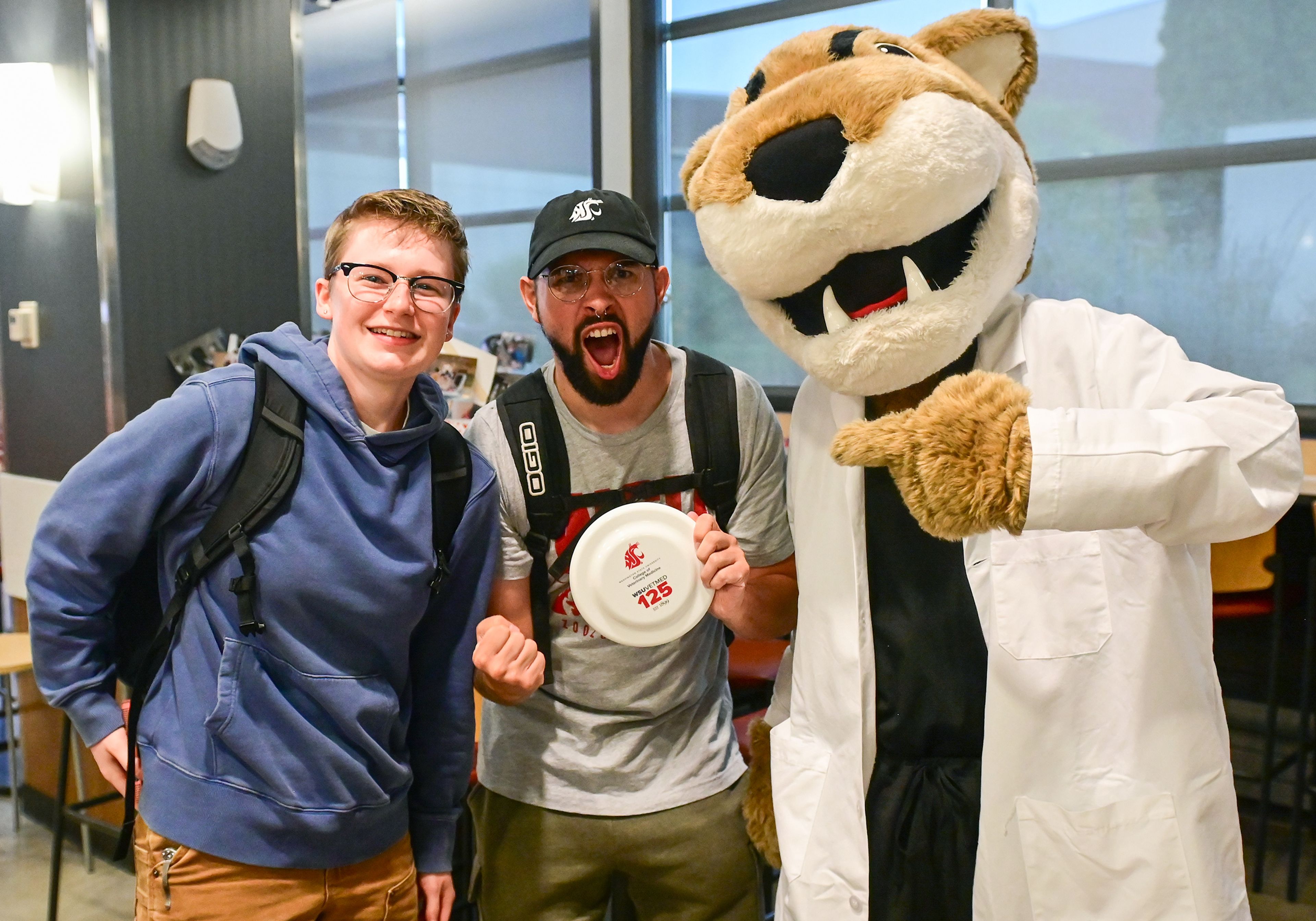 Prospective students of the Washington State University College of Veterinary Medicine Taylor Jackson, left, and Matt Schimmer pose with WSU mascot Butch T. Cougar at a 125th anniversary celebration for the college Friday in Pullman.