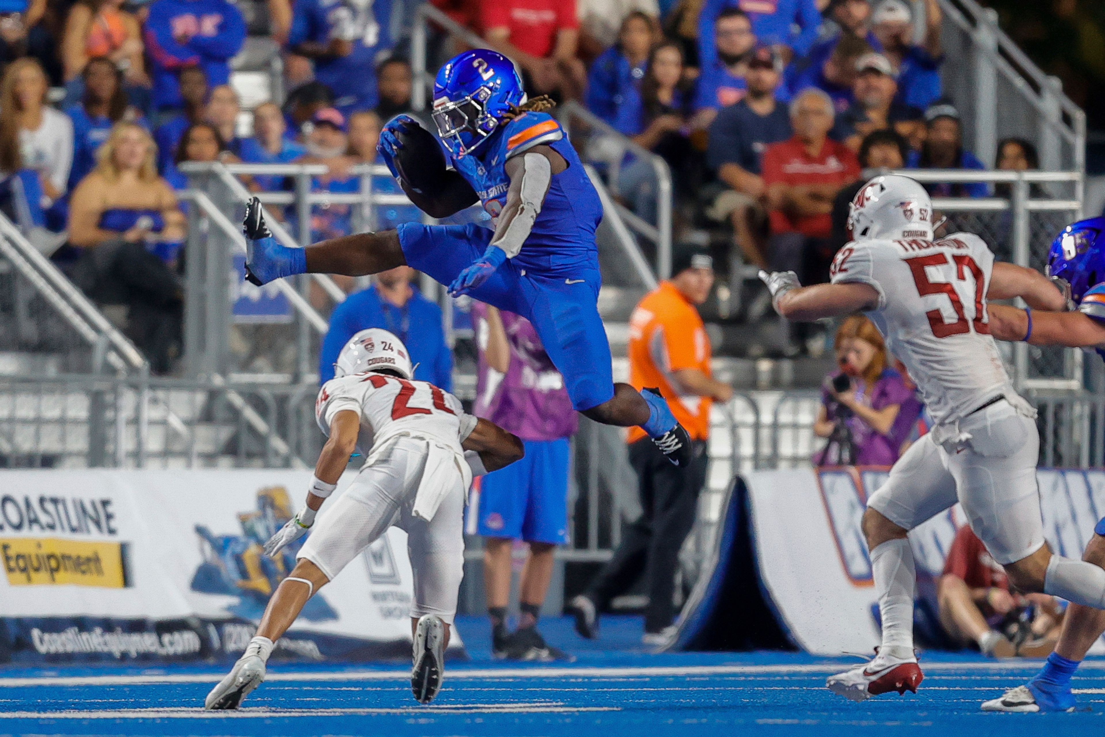 Boise State running back Ashton Jeanty (2) hurdles Washington State defensive back Ethan O'Connor (24) on a run in the second quarter of an NCAA college football game, Saturday, Sept. 28, 2024, in Boise, Idaho. (AP Photo/Steve Conner)