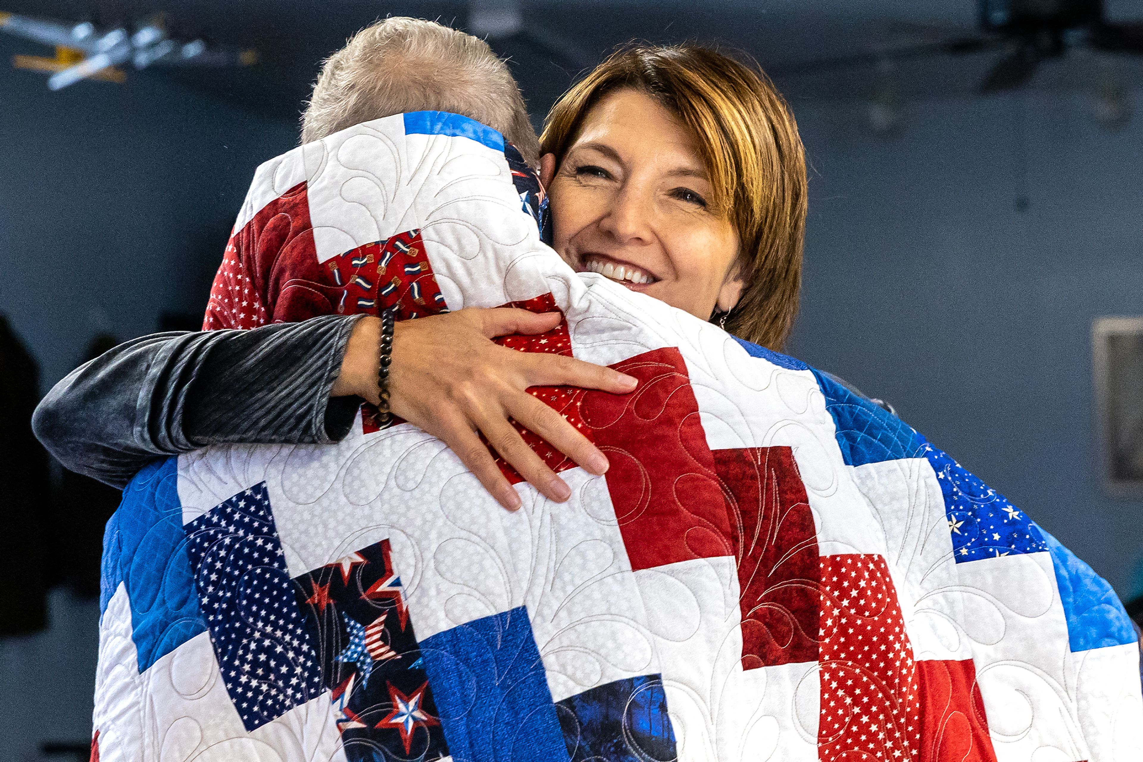 Washington Representative Cathy McMorris Rodgers embraces Dennis Rousseau after receiving a quilt of valor Friday in Clarkston.