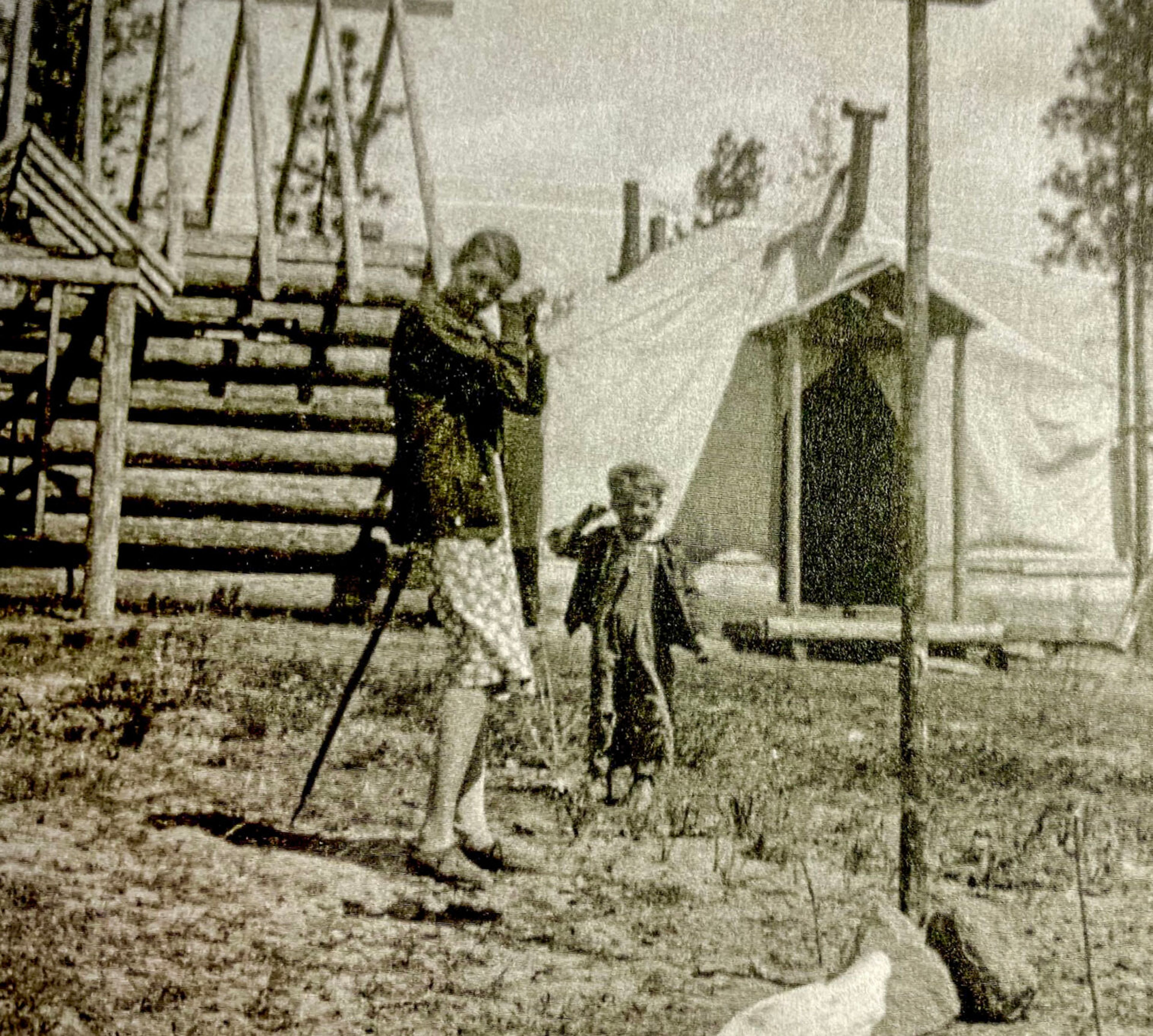 Margaret Bull and her son, Stanley Stater, stand in front of the cabin under construction at the Hatter Creek farm. The family lived in the tent until the cabin was finished. (Alec Bull photo)