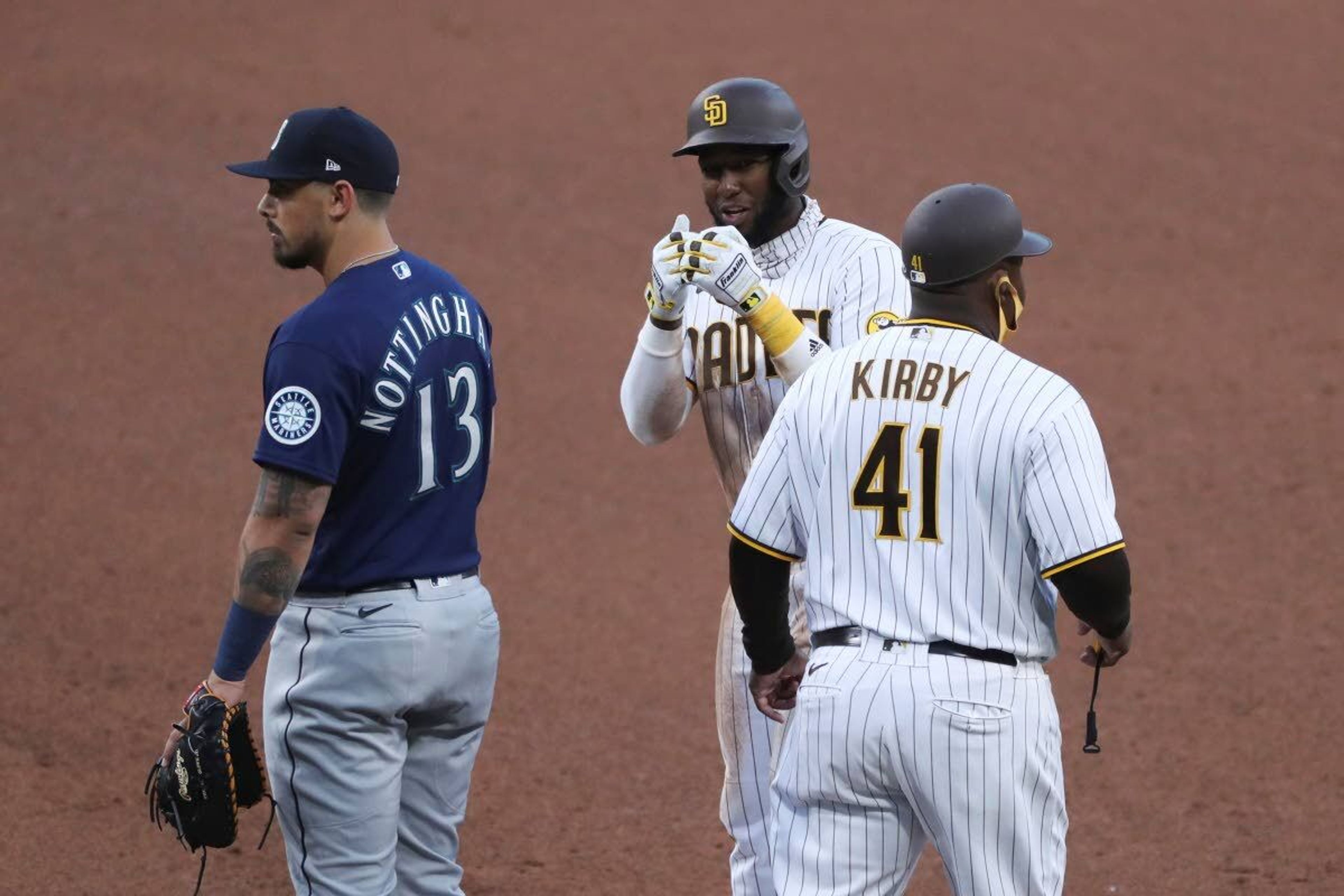 San Diego Padres' Jurickson Profar gestures toward the Padres dugout after singling to right field off Seattle Mariners' Justus Sheffield in the fifth inning of a baseball game Saturday, May 22, 2021, in San Diego. Tommy Pham advanced to third. (AP Photo/Derrick Tuskan)