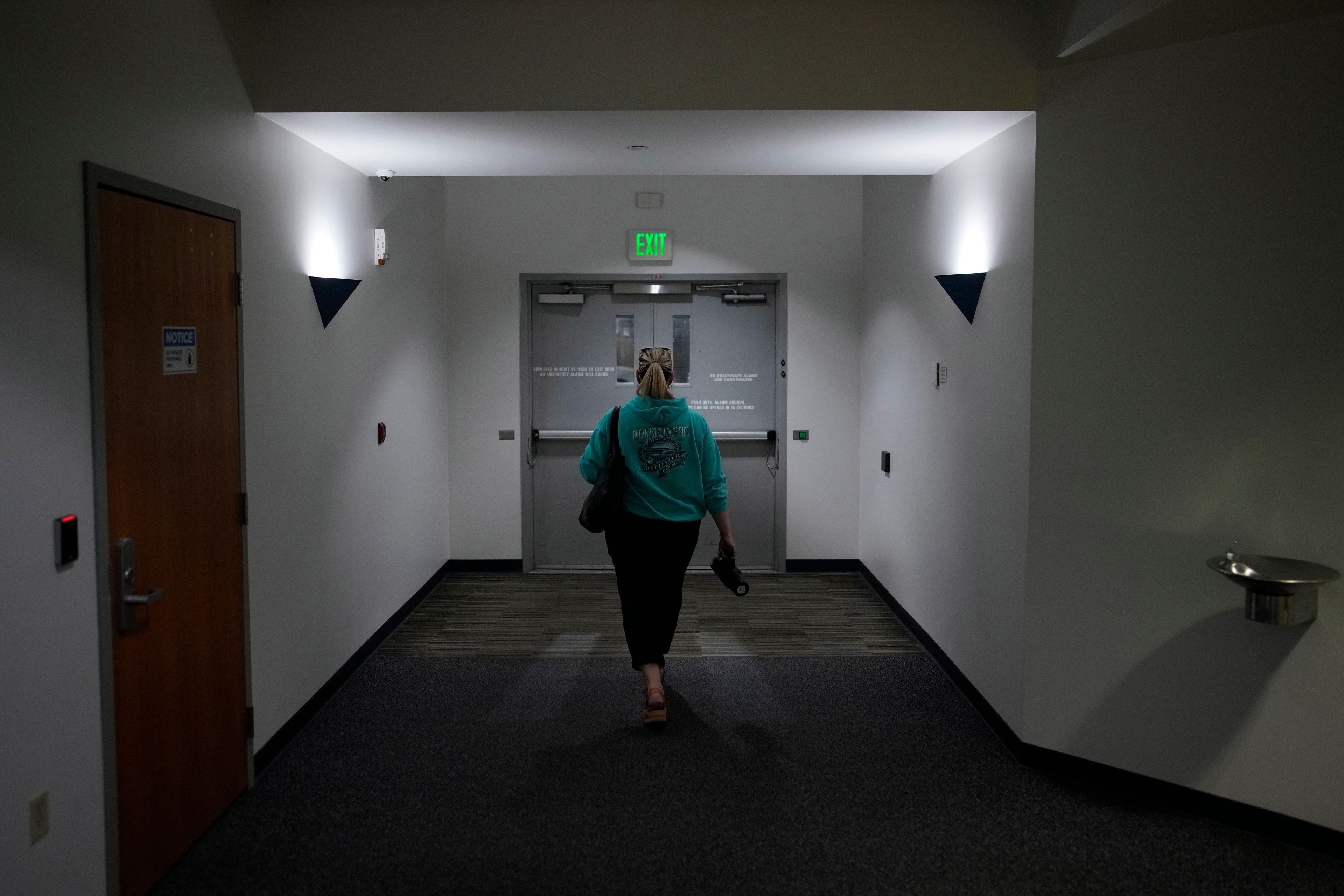 Cari-Ann Burgess, interim Registrar of Voters for Washoe County, Nev., leaves the office after working Saturday, Sept. 21, 2024, in Reno, Nev. (AP Photo/John Locher)