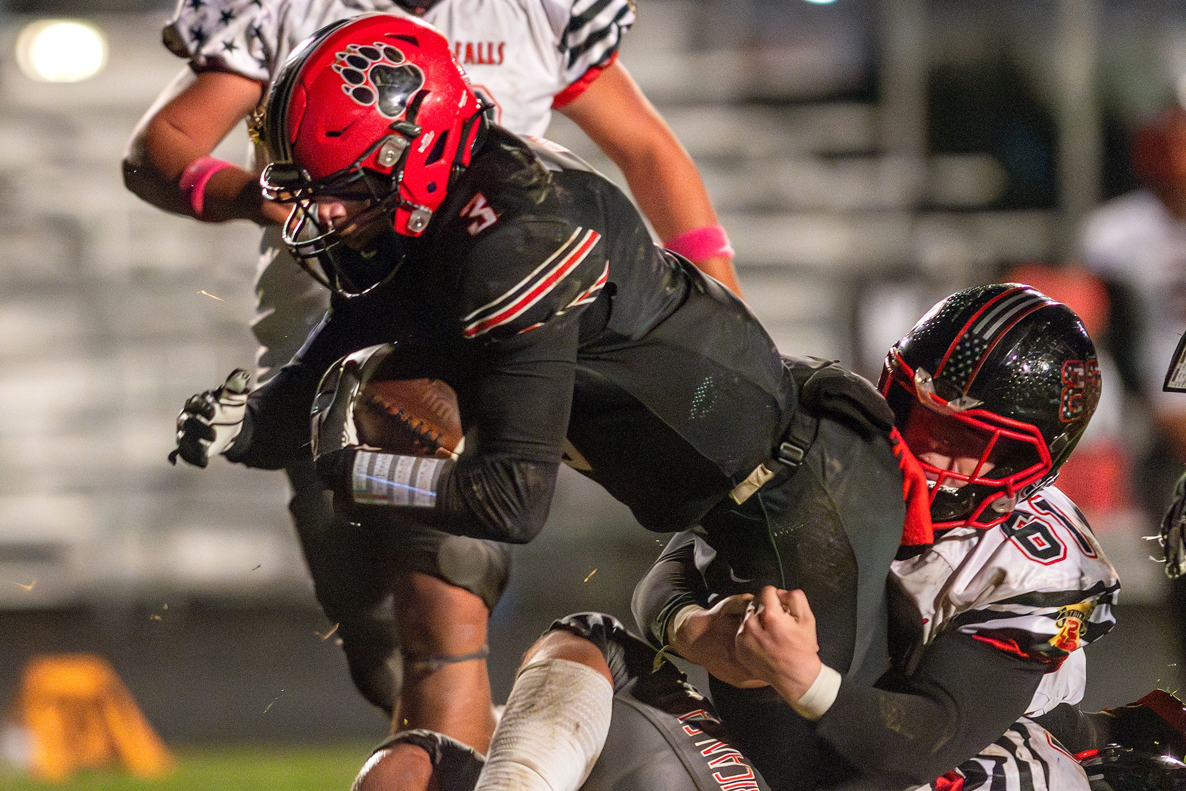 Moscow running back Tyson Izzo is brought down by American Falls' Ty Smith during an Idaho 4A playoff game Friday in Moscow.