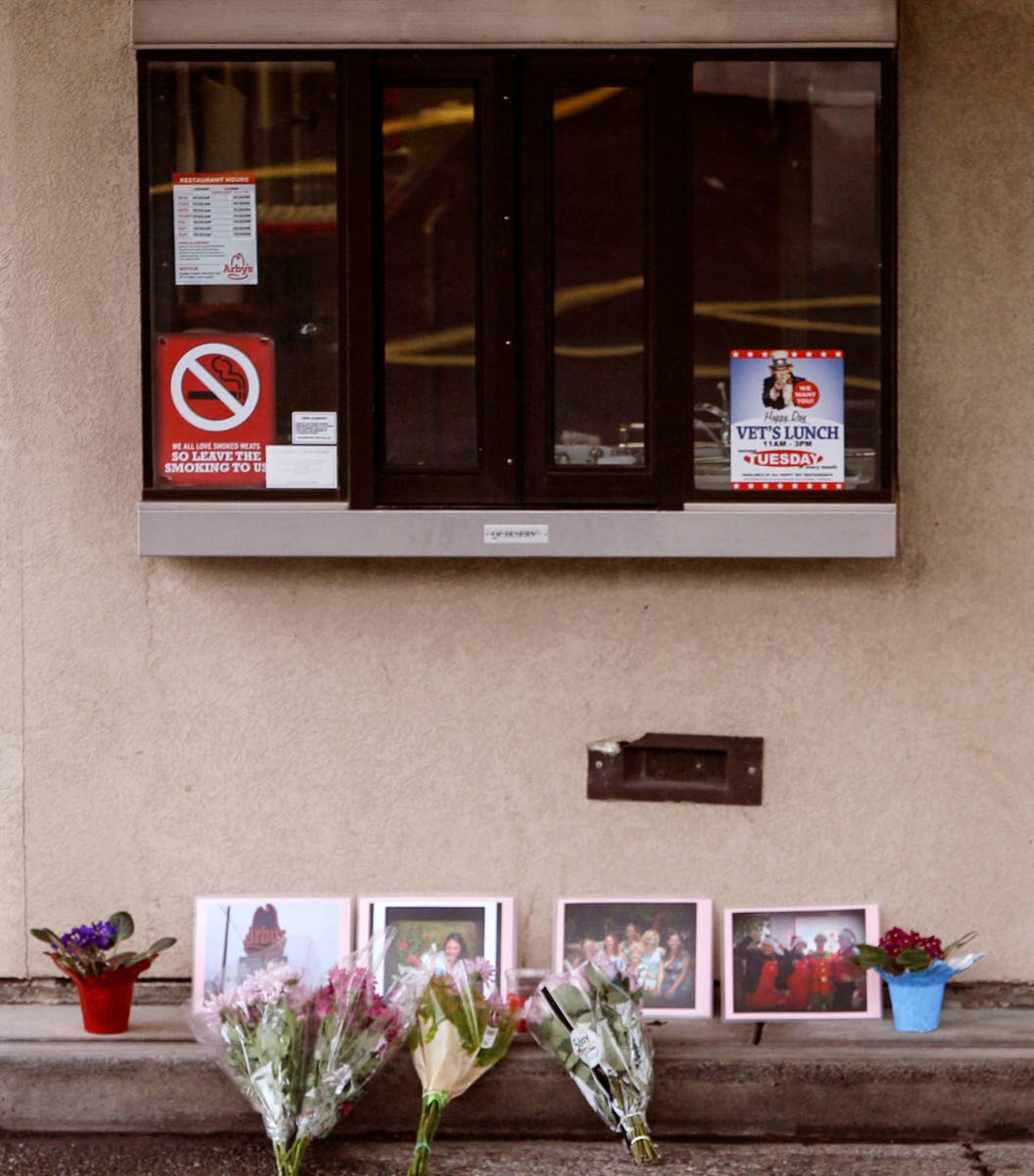 Memorial photos and flowers for Belinda Niebuhr are seen outside the drive-through window at Arby's in 2015 in Moscow.