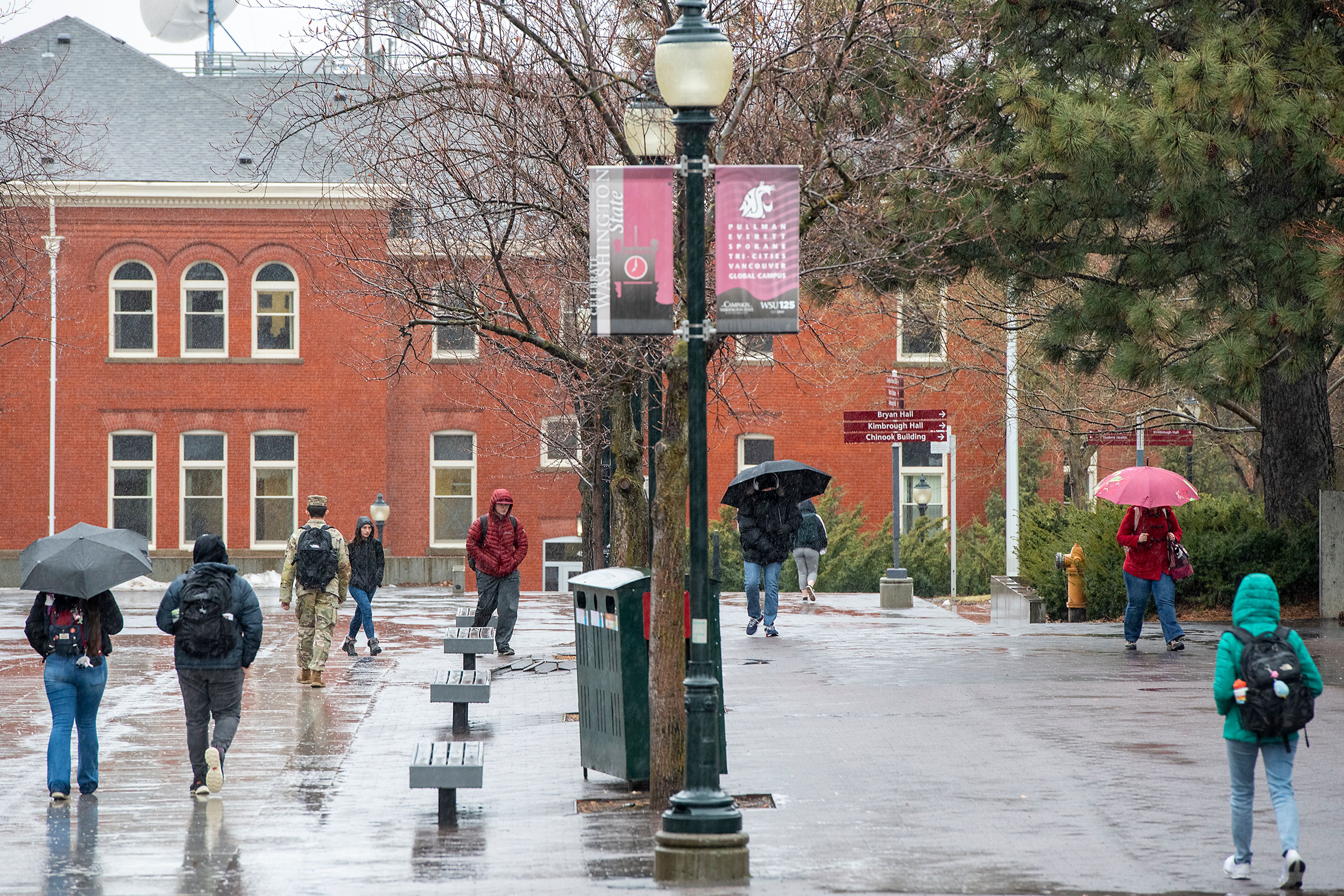 Washington State University students walk through rainfall Monday on the first day of spring semester in Pullman.