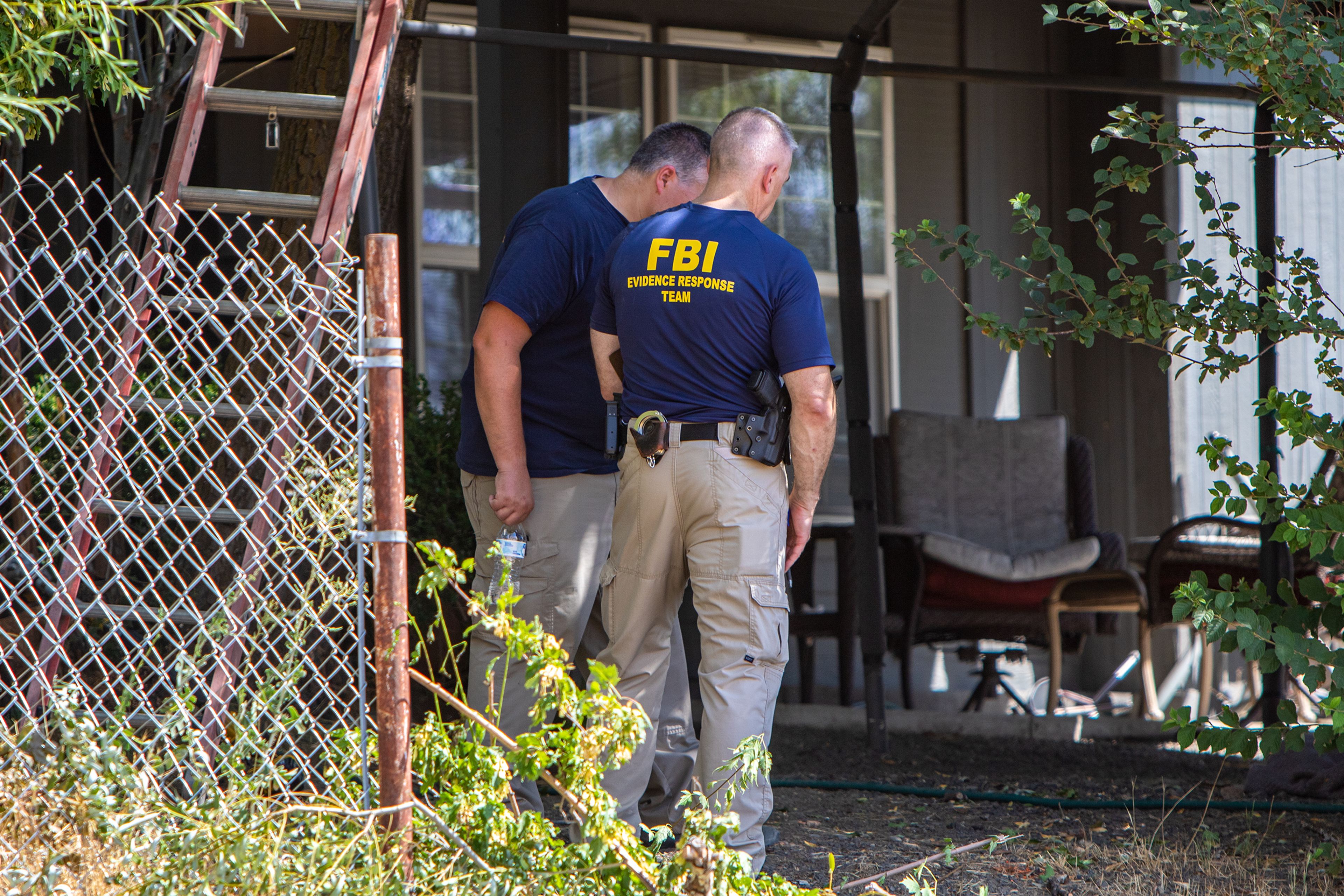 FBI agents and local law enforcement investigate the scene of a suspected homicide Tuesday at a home on Harvest Road in North Lewiston. Mother and daughter Kay and Kimberly Morrison were arrested Tuesday and charged with first-degree murder in the death of Kenneth Morrison, who was their ex-husband and father.