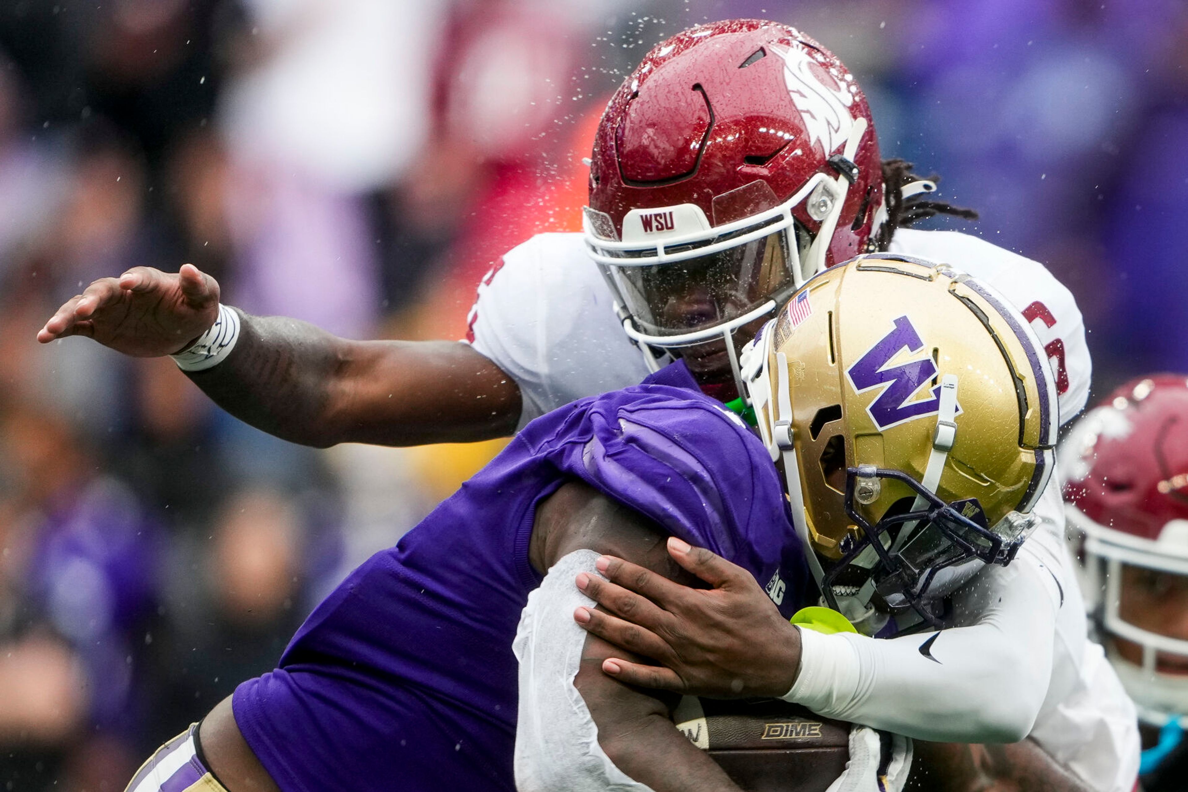 Washington running back Jonah Coleman is tackled by Washington State defensive back Adrian Wilson (6) during the second half of an NCAA college football game Saturday, Sept. 14, 2024, in Seattle. Washington State won 24-19. (AP Photo/Lindsey Wasson)