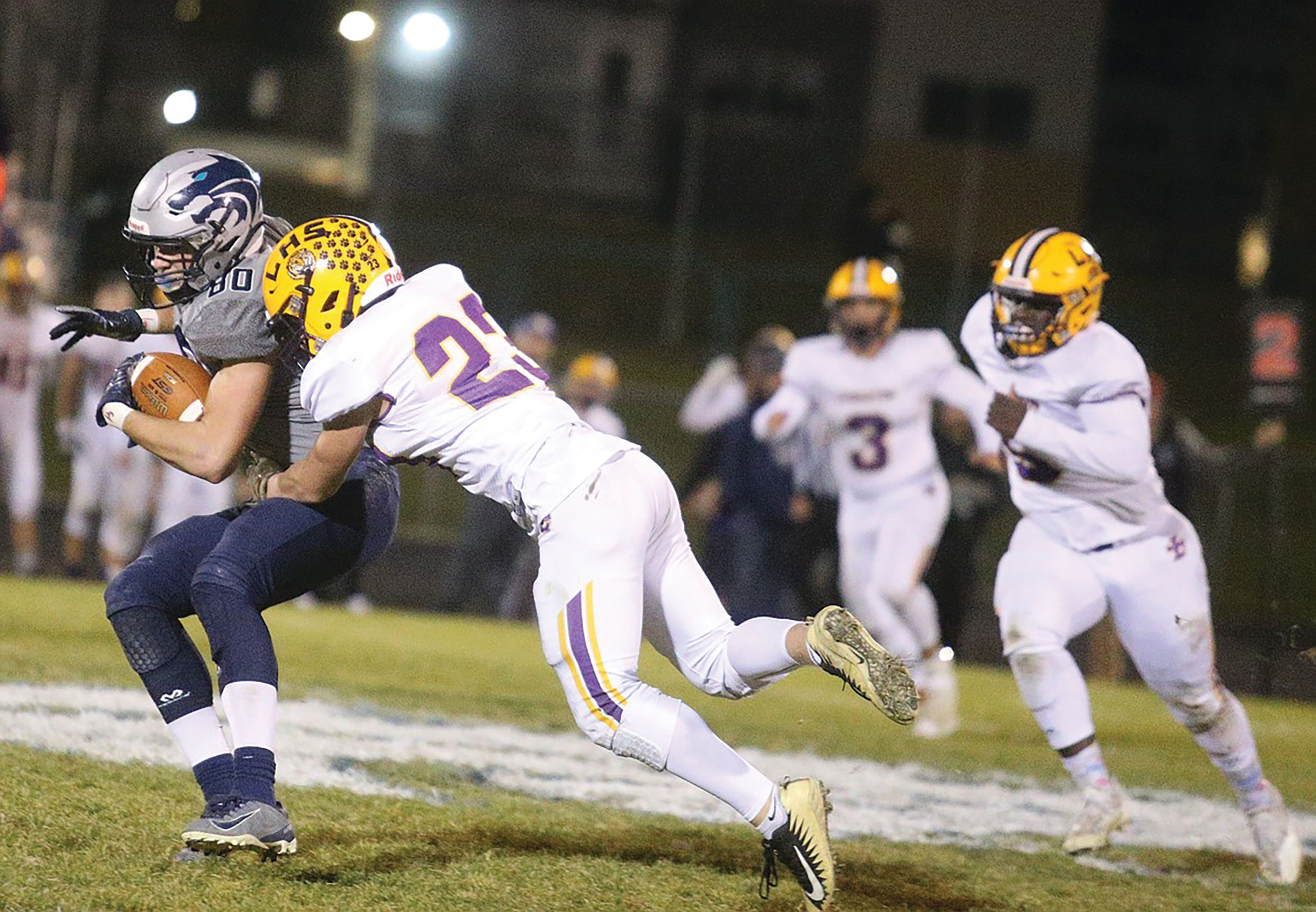 Jason Elliott/Coeur d'Alene Press Lake City's Zach Johnson catches a pass during a 2021 game against Lewiston. Johnson signed a national letter of intent Wednesday to play at Idaho.