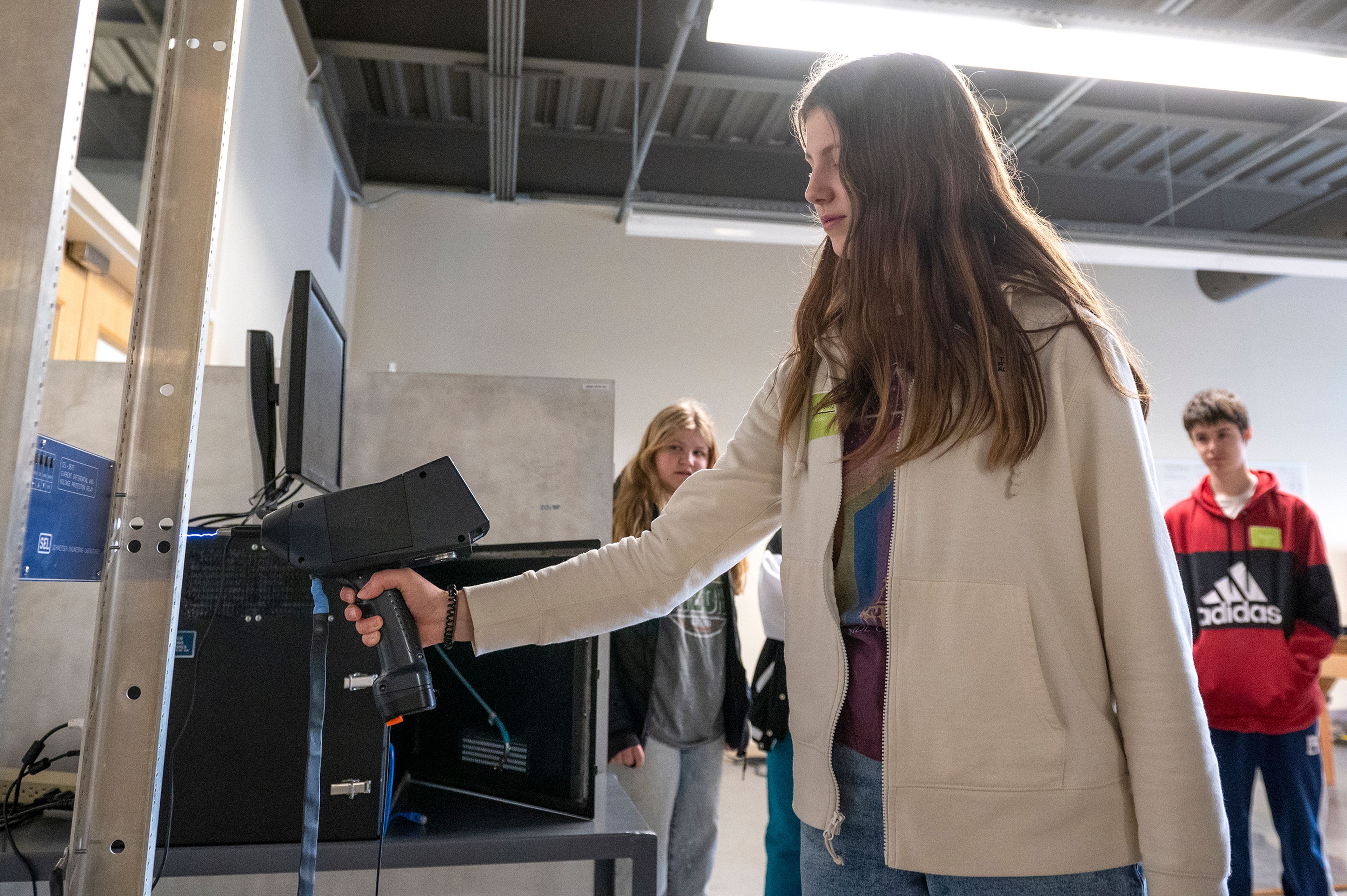 Joelle Lewis of All Saints Catholic School uses an electrostatic discharge gun on a tour Thursday during the annual Getting Ready for Engineering and Technology Day, or GREAT DAY at Schweitzer Engineering Laboratories in Pullman.