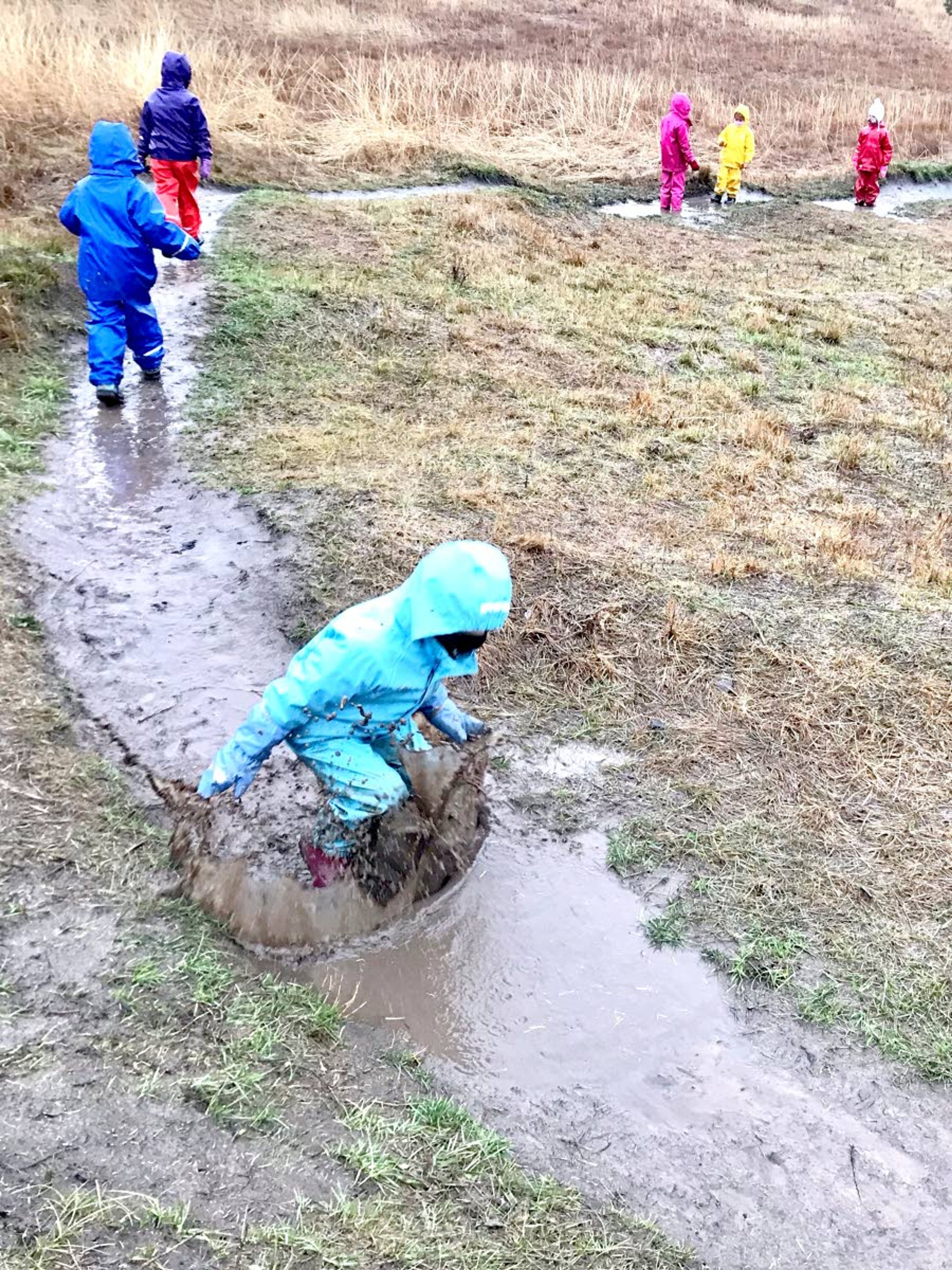 Courtesy Misha ClevelandIn waterproof rain gear, students in the Palouse Roots program are free to splash and get as muddy as they want at a recent adventure on the grounds of Palouse-Clearwater Environmental Institute in Moscow.