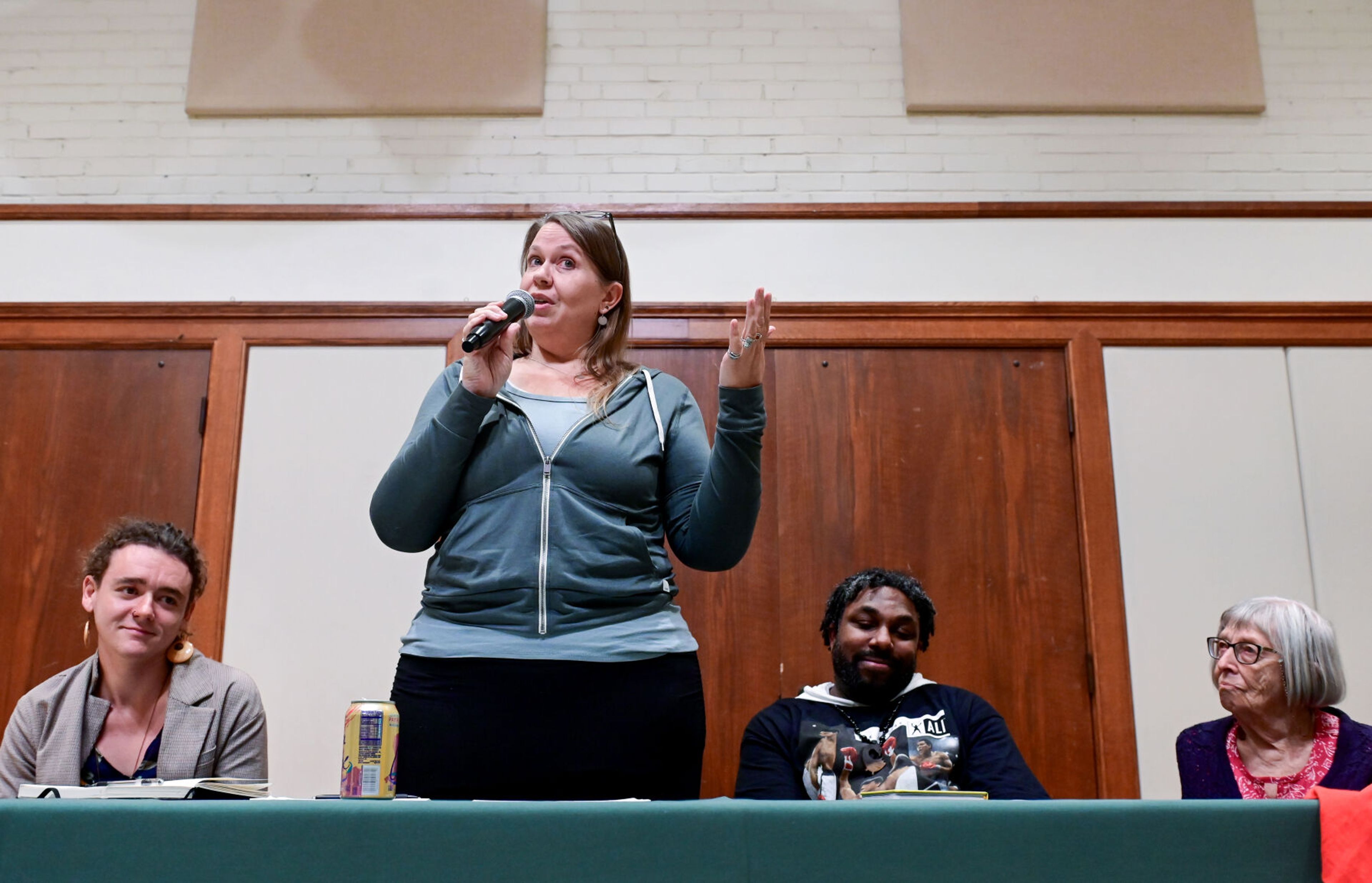 Melinda Schab, standing, general manager of Moscow Food Co-op, speaks as part of a local panel at the United Against Hate summit Monday at the 1912 Center in Moscow. Schab is joined by Nick Koenig, from left, a University of Idaho graduate student, Mario Pile, director of the UI Black and African American Cultural Center, and Joann Muneta, chair of the Latah County Human Rights Task Force.