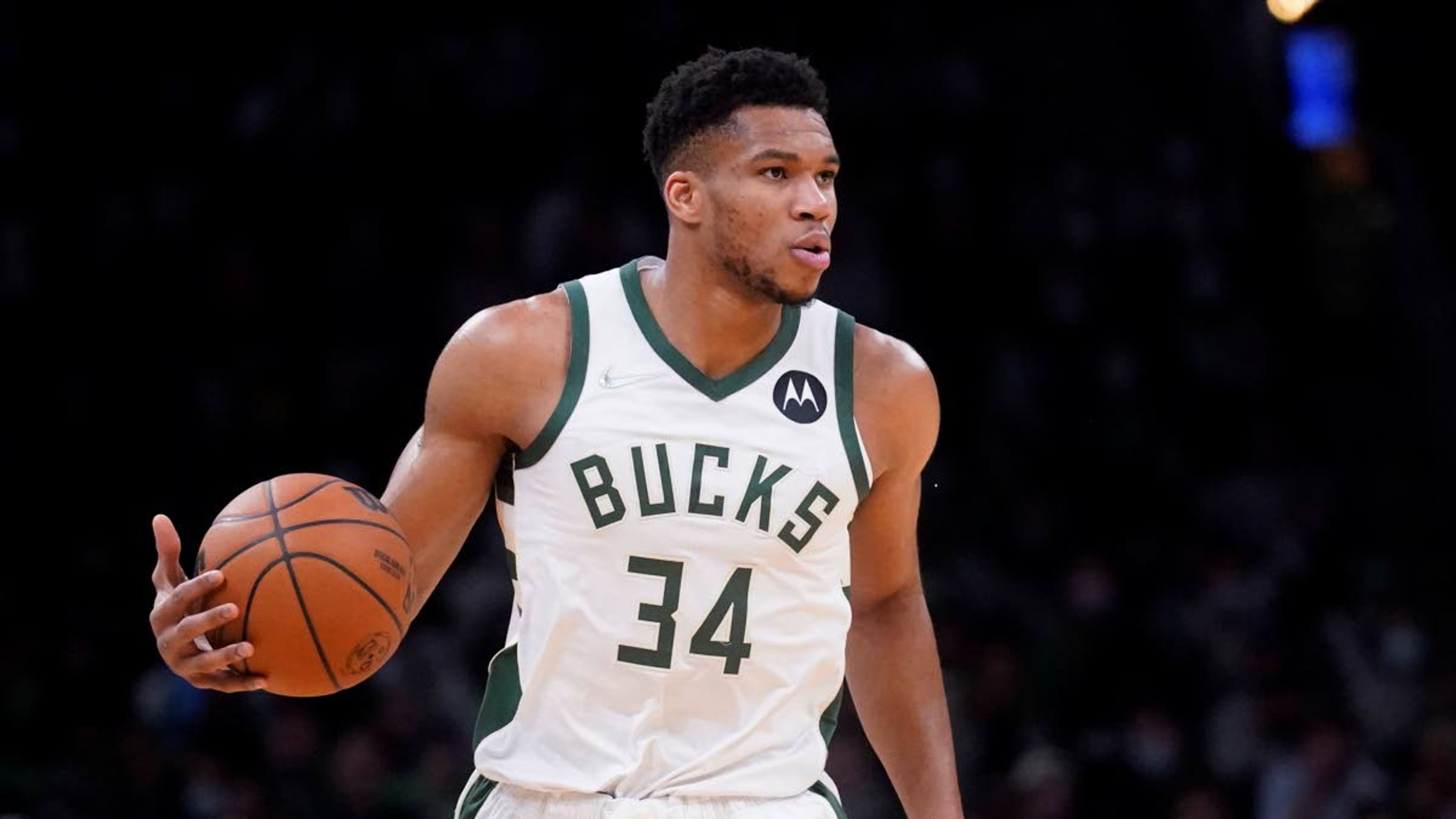 Milwaukee Bucks forward Giannis Antetokounmpo (34) brings the ball upcourt during the first half of an NBA basketball game against the Boston Celtics, Monday, Dec. 13, 2021, in Boston. (AP Photo/Charles Krupa)