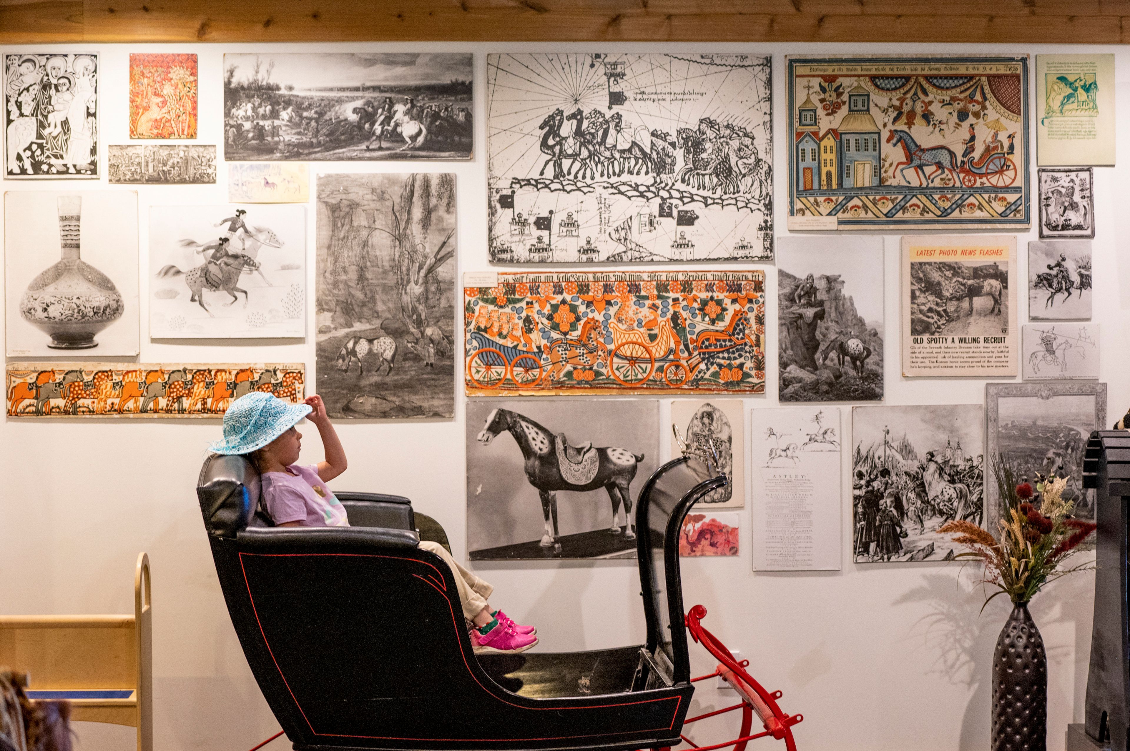 Mia Jackson, 6, leans back in a sleigh while observing the Appaloosa Museum and Heritage Center during Appy Festival on Thursday in Moscow.