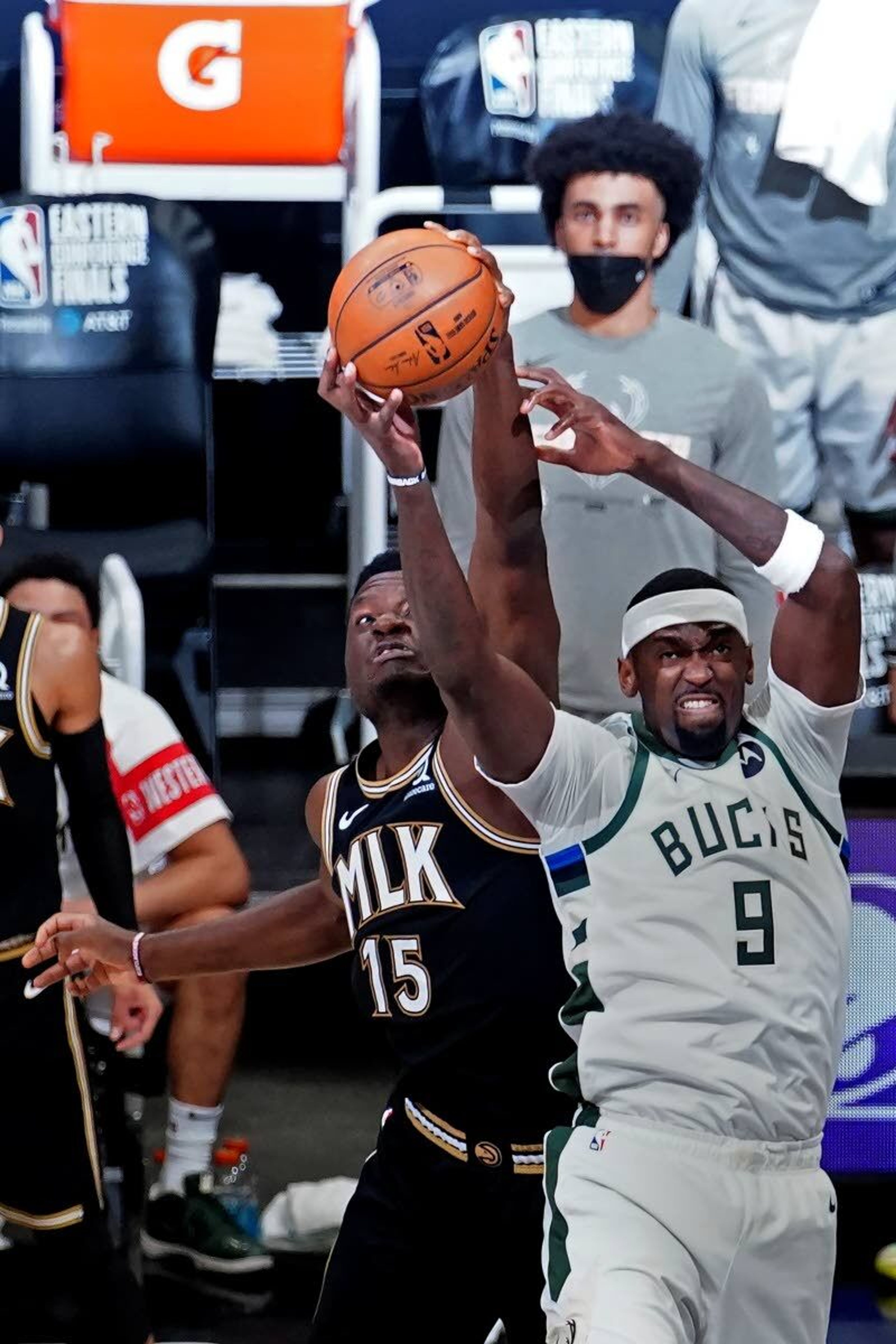 Milwaukee Bucks center Bobby Portis (9) and Atlanta Hawks center Clint Capela (15) reach for a rebound during the first half in Game 6 of the Eastern Conference finals in the NBA basketball playoffs Saturday, July 3, 2021, in Atlanta. (AP Photo/John Bazemore)