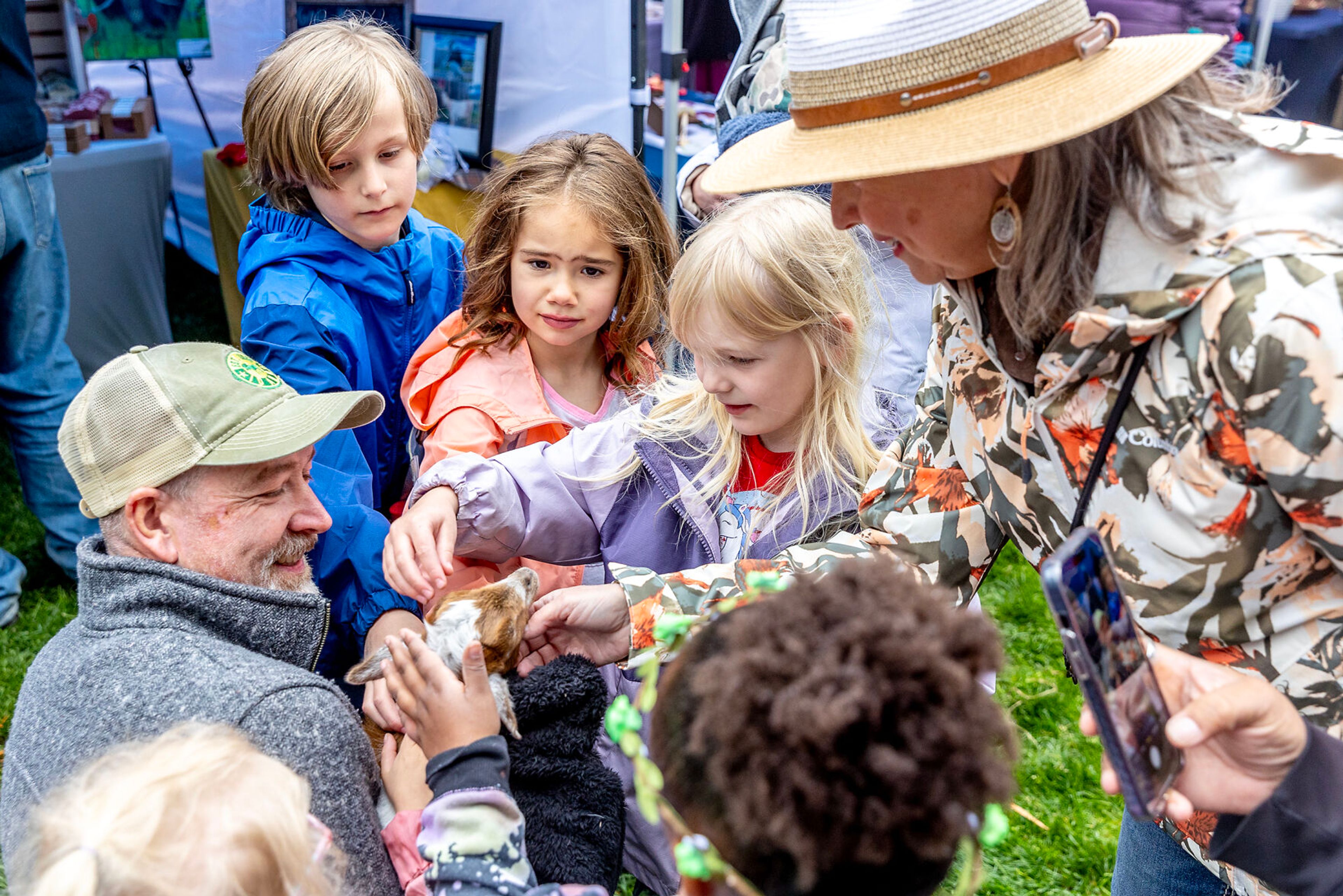 Jerry Williams holds Fin, the run from a litter of four, as people crowd around to pet him at the Moscow Renaissance Fair Saturday at East City Park in Moscow. Fin is the new mascot of Terry Williams’ Green Valley Soaps and Lotions.