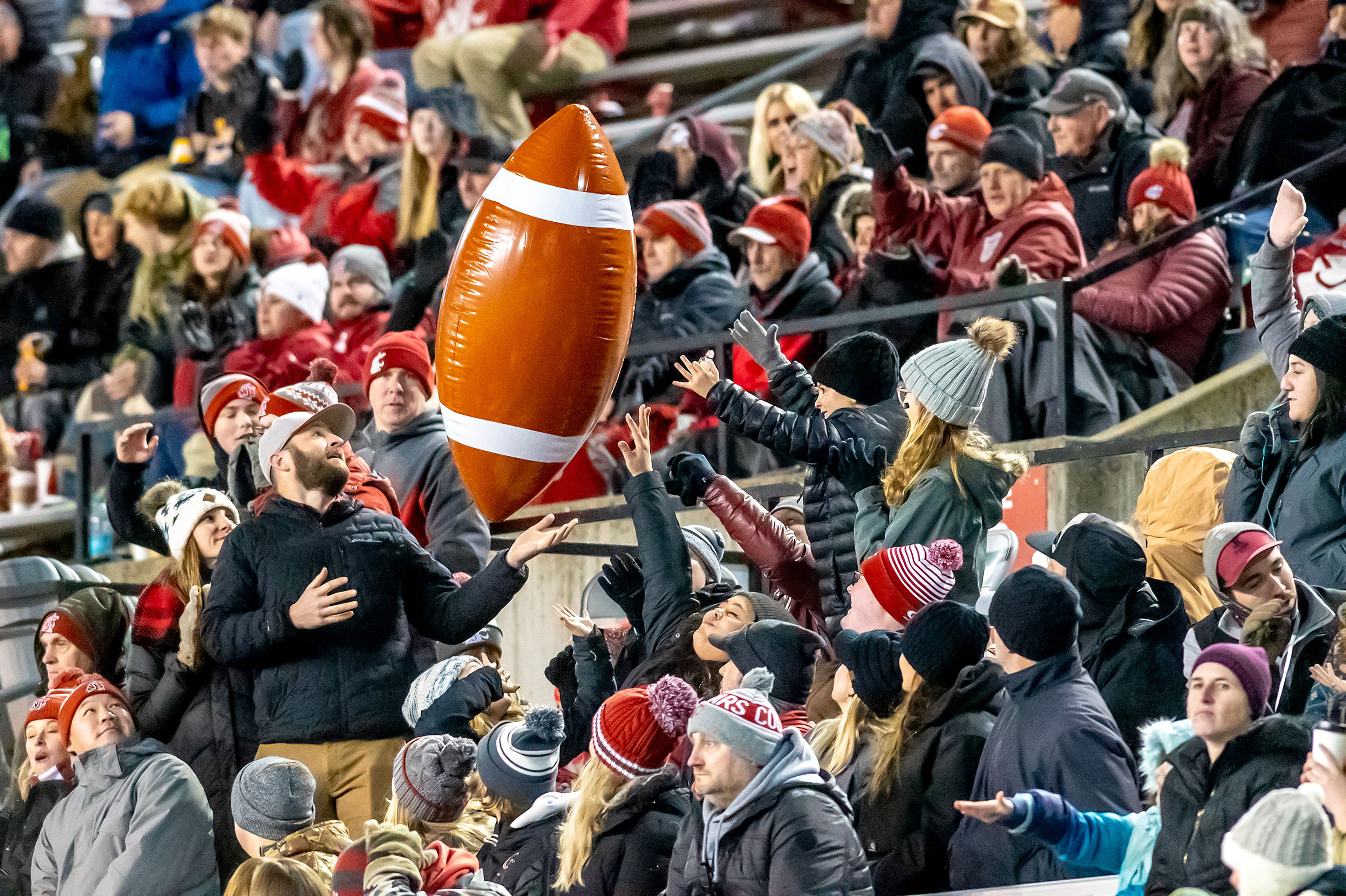 Fans hit an inflatable football around during a quarter of a college football game between Washington State  and Wyoming on Saturday, at Gesa Field in Pullman. Wyoming defeated Washington State 15-14.