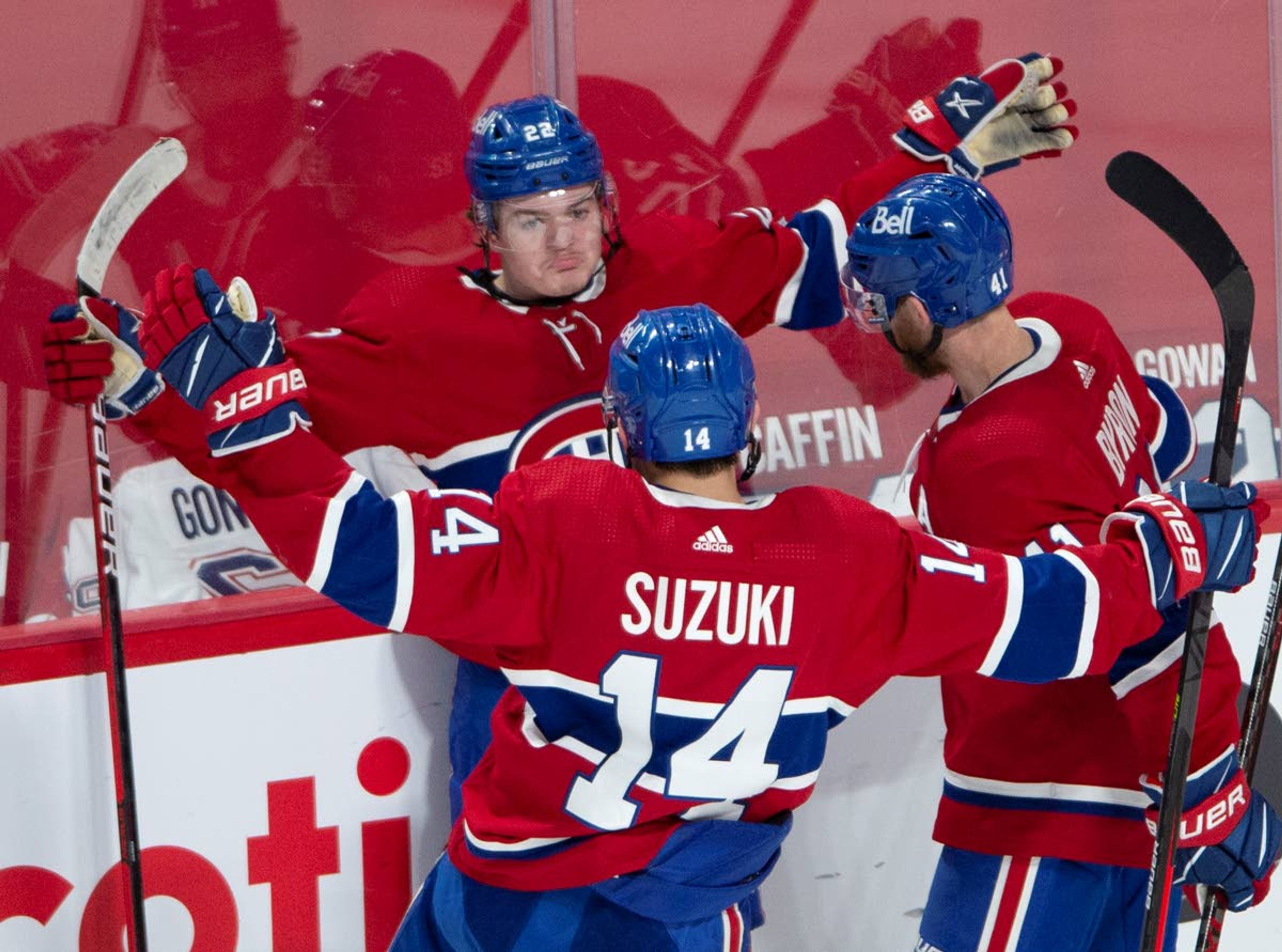 Montreal Canadiens right wing Cole Caufield (22) celebrates his goal against the Vegas Golden Knights with teammates Nick Suzuki (14) and Paul Byron (41) during the second period in Game 6 of an NHL hockey Stanley Cup semifinal playoff series Thursday, June 24, 2021 in Montreal. (Ryan Remiorz/The Canadian Press via AP)