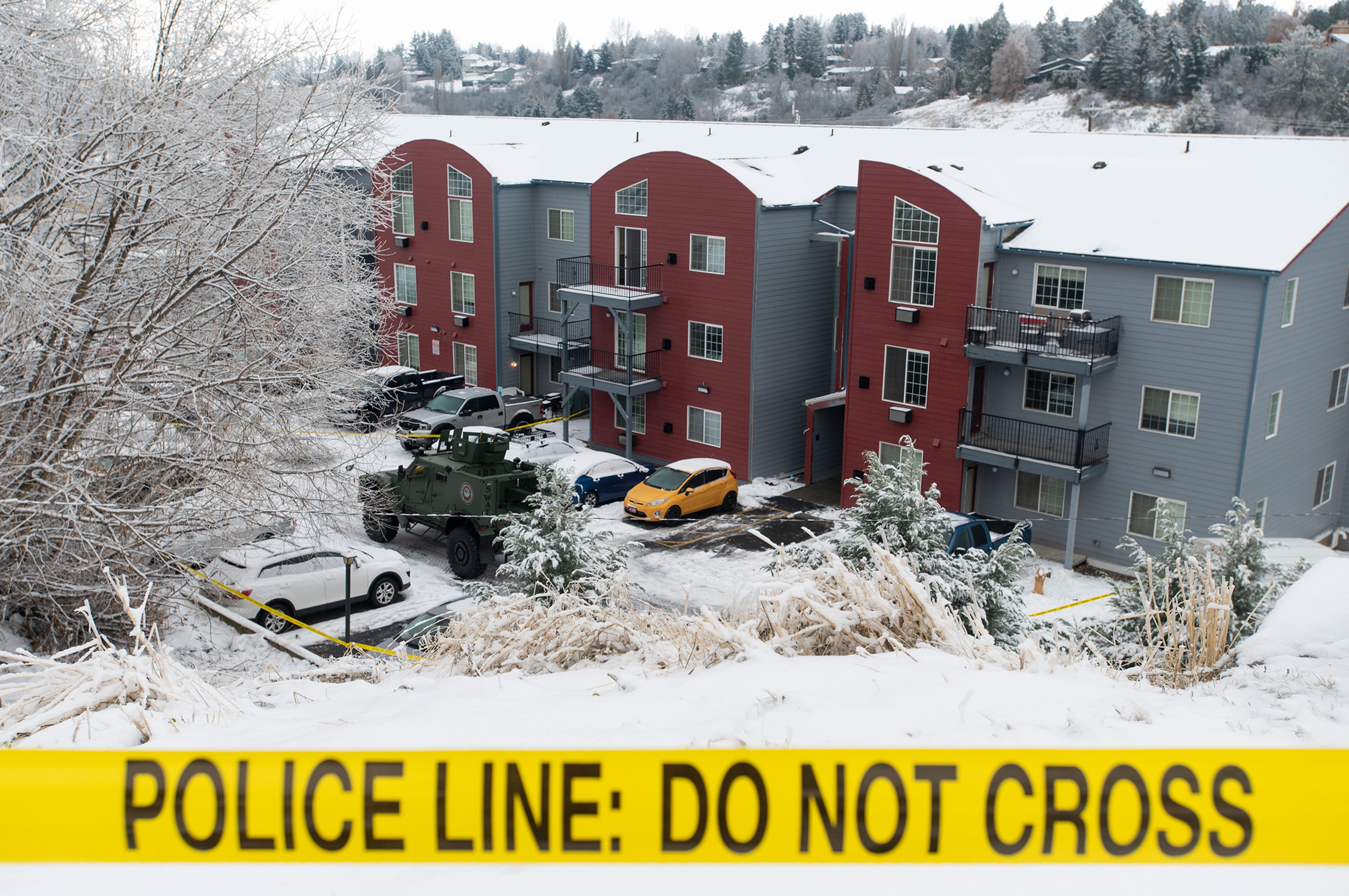 Caution tape is strung in front of the Coffee House Apartment complex Thursday where a member of the Whitman County Regional SWAT Team shot and killed a man in a standoff Wednesday night, according to a Pullman Police Department news release.