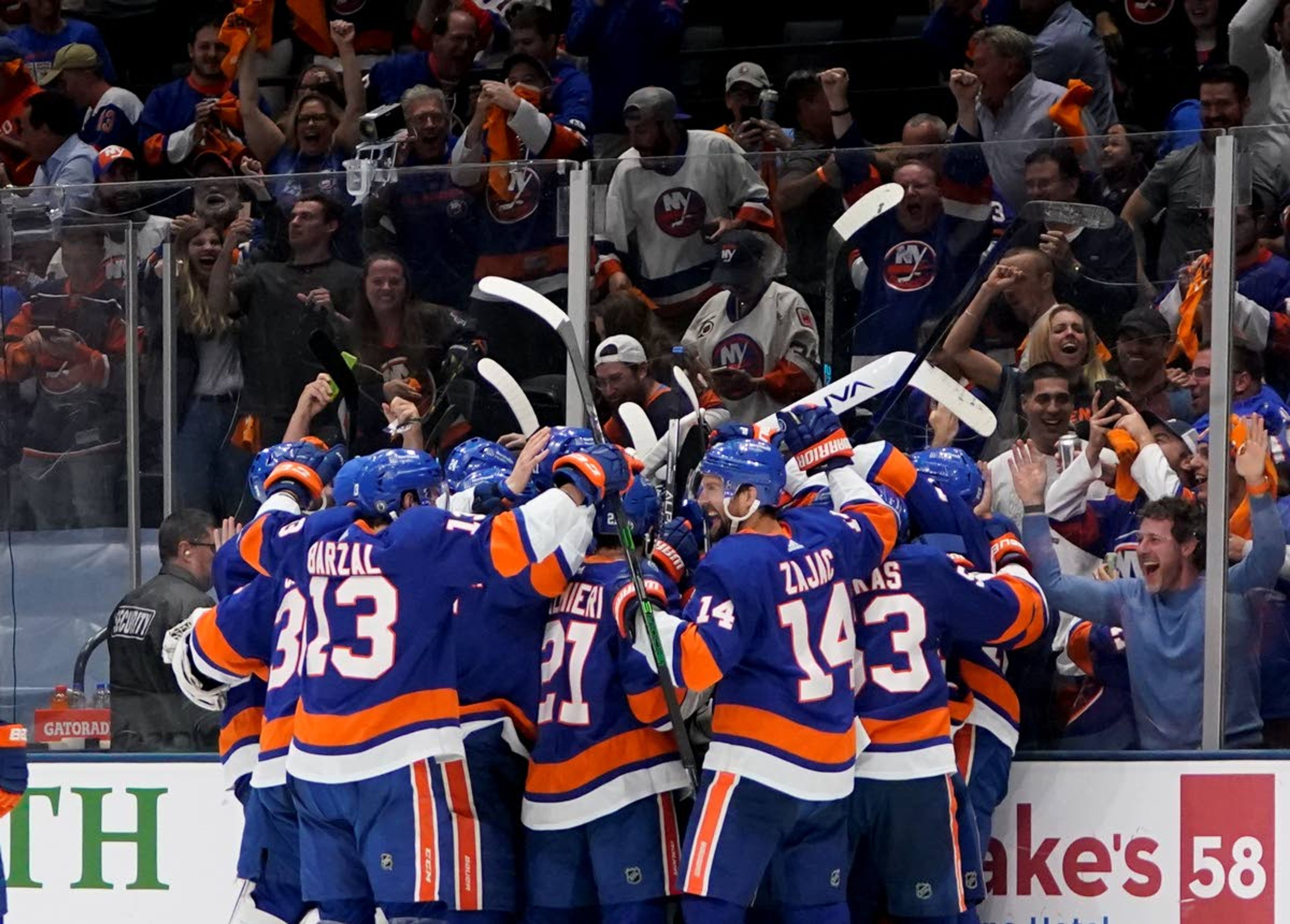 The New York Islanders celebrate after scoring in sudden death overtime against the Tampa Bay Lightning to win Game 6 of the NHL hockey Stanley Cup semifinals 3-2, Wednesday, June 23, 2021, in Uniondale, N.Y. (AP Photo/Frank Franklin II)