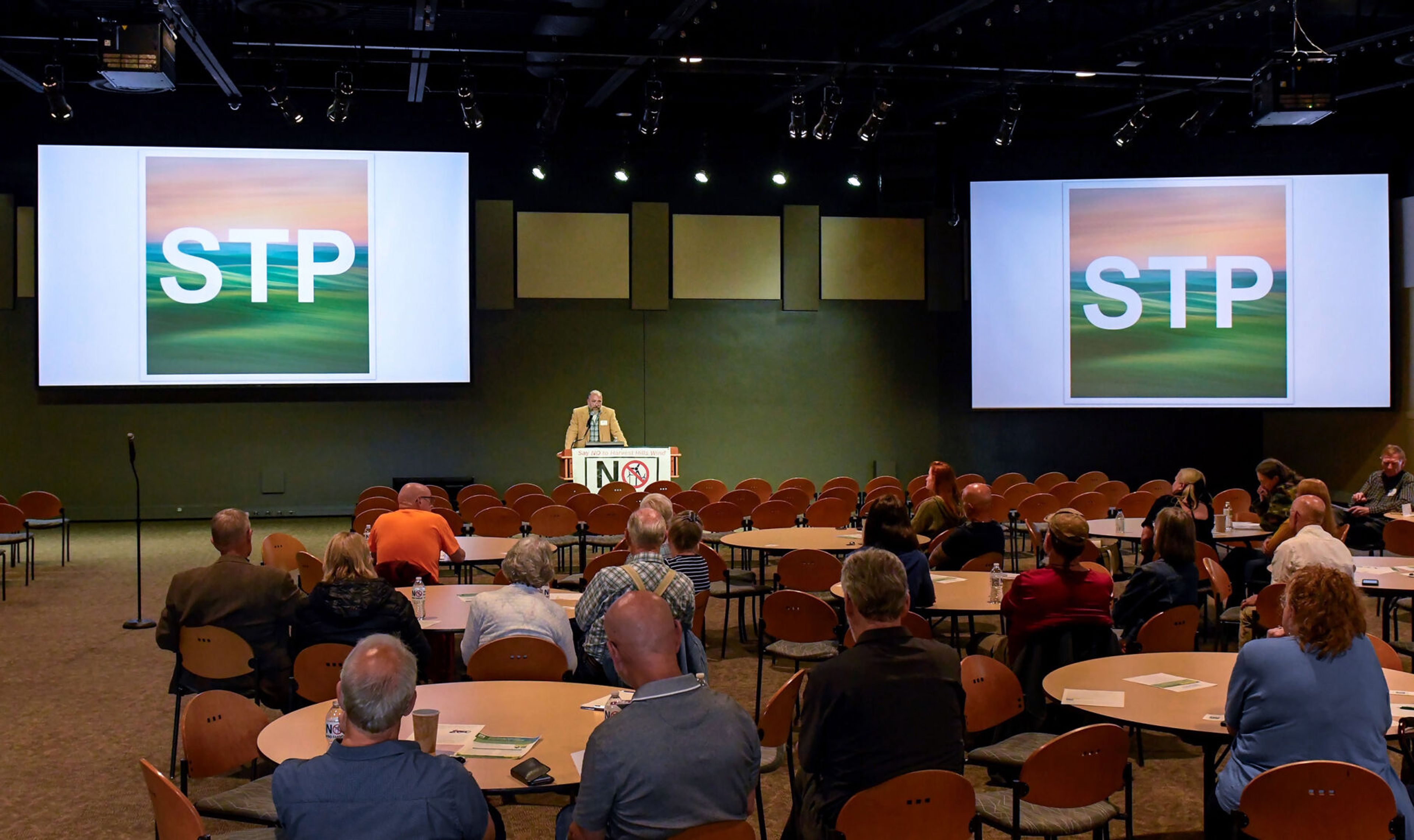 Mike Dymkoski, center, speaks at a public meeting for Save the Palouse on Thursday in Pullman.