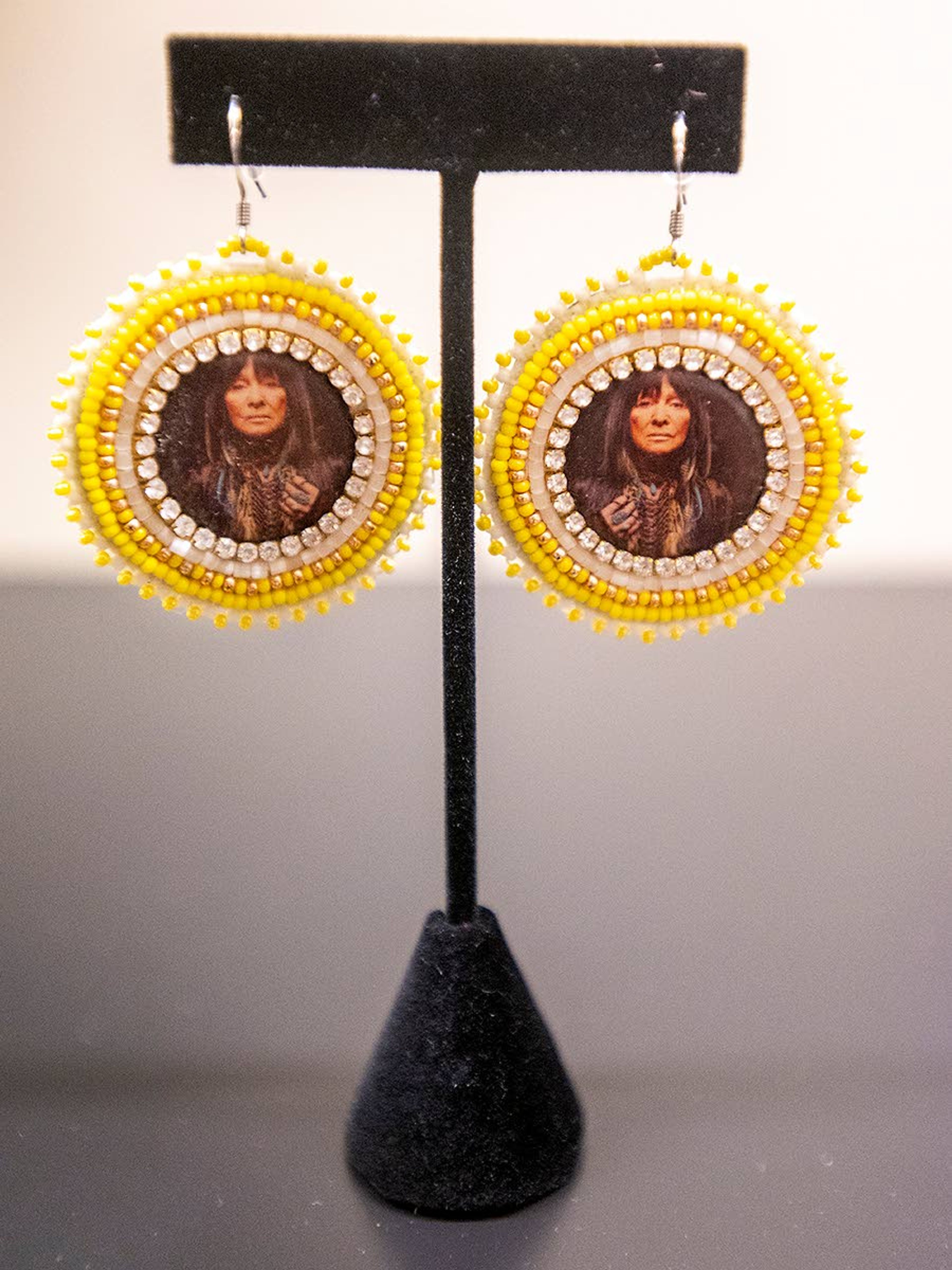 Earrings with pictures of Alaskan native throat singer Buffy Saint-Marie are displayed in Mondejar’s art exhibit. “Her songs are amazing,” Mondejar said.