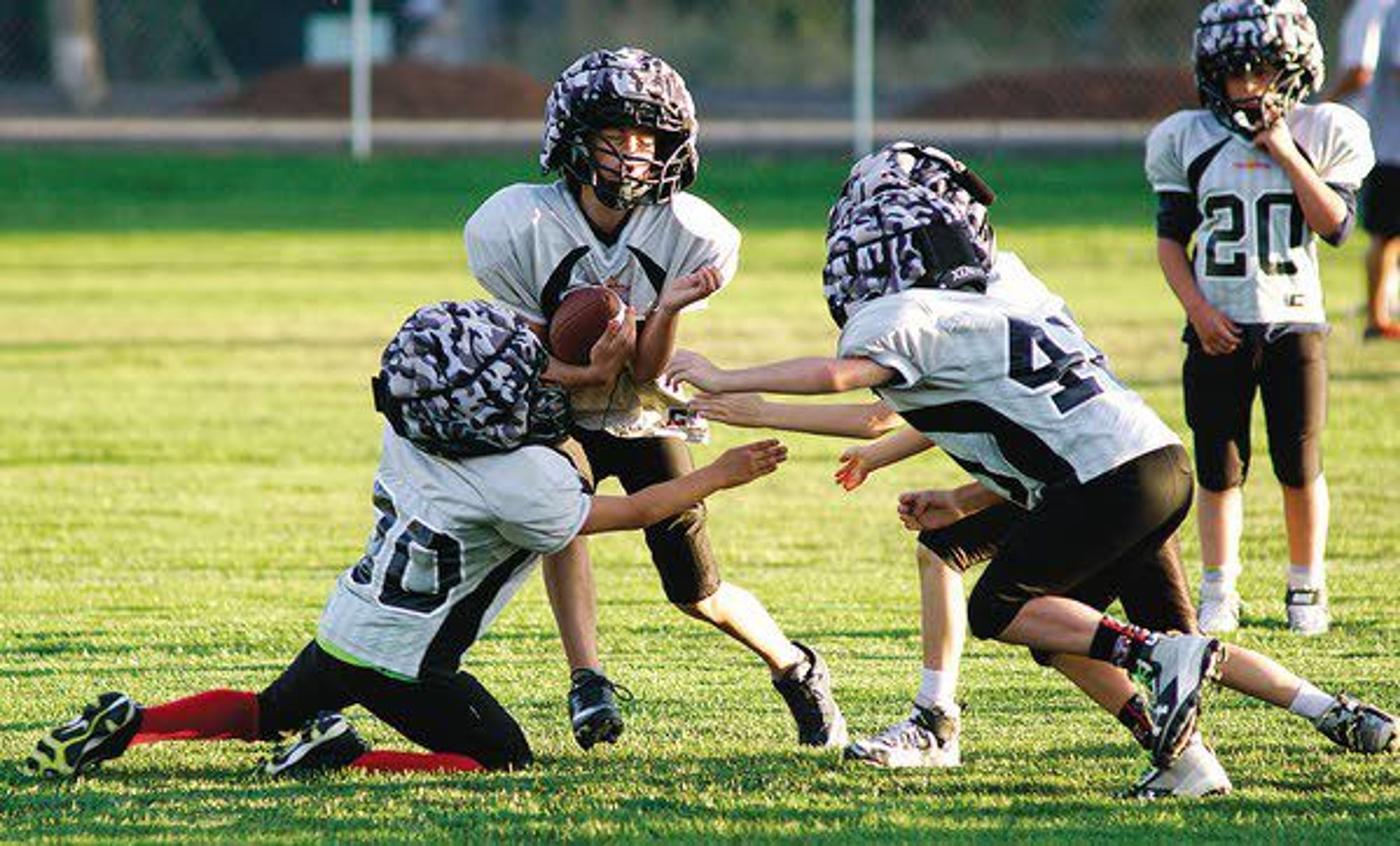 Players on the Moscow Thrashers silver team, comprised of third- and fourth- graders, practice tackling Wednesday evening.