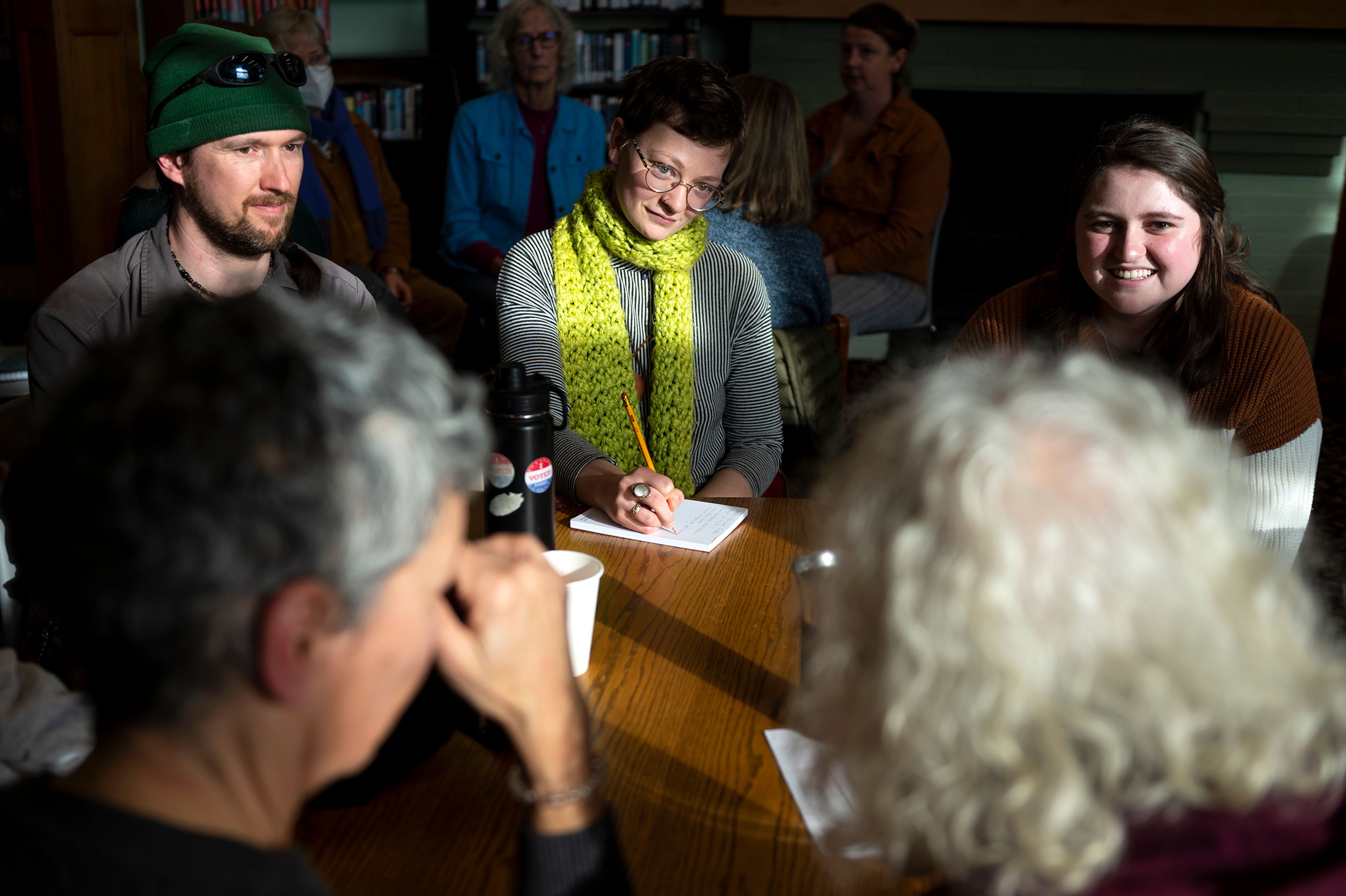 Thomas McDonough, from left, Cydnie Gray and Emily discuss the topic of death in a small group during a Death Café at the Moscow Public Library on Tuesday.