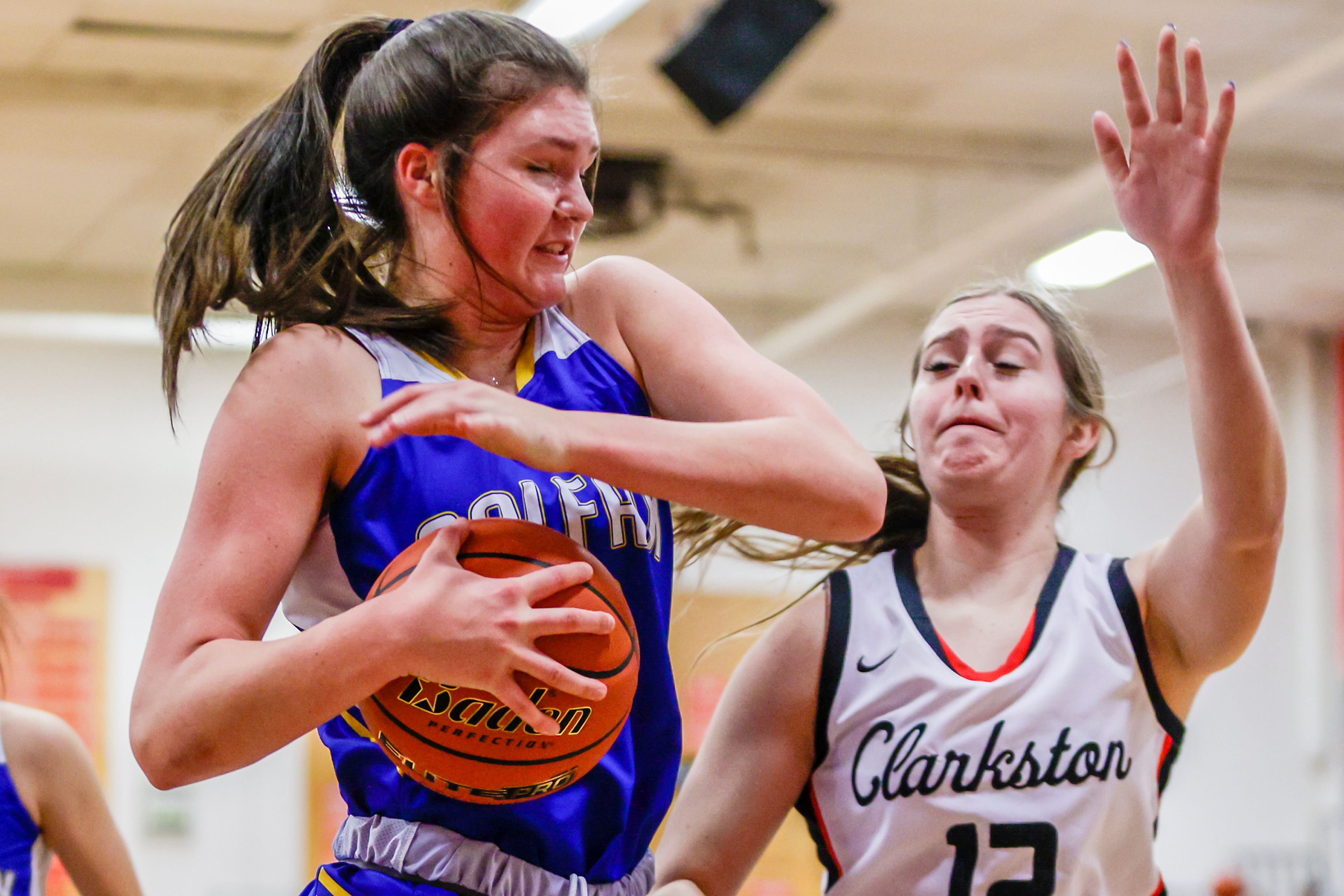 Colfax post Brynn McGaughy wrestles the ball away from Clarkston wing/post Ryann Combs in a quarter of a nonleague game Thursday at Clarkston.