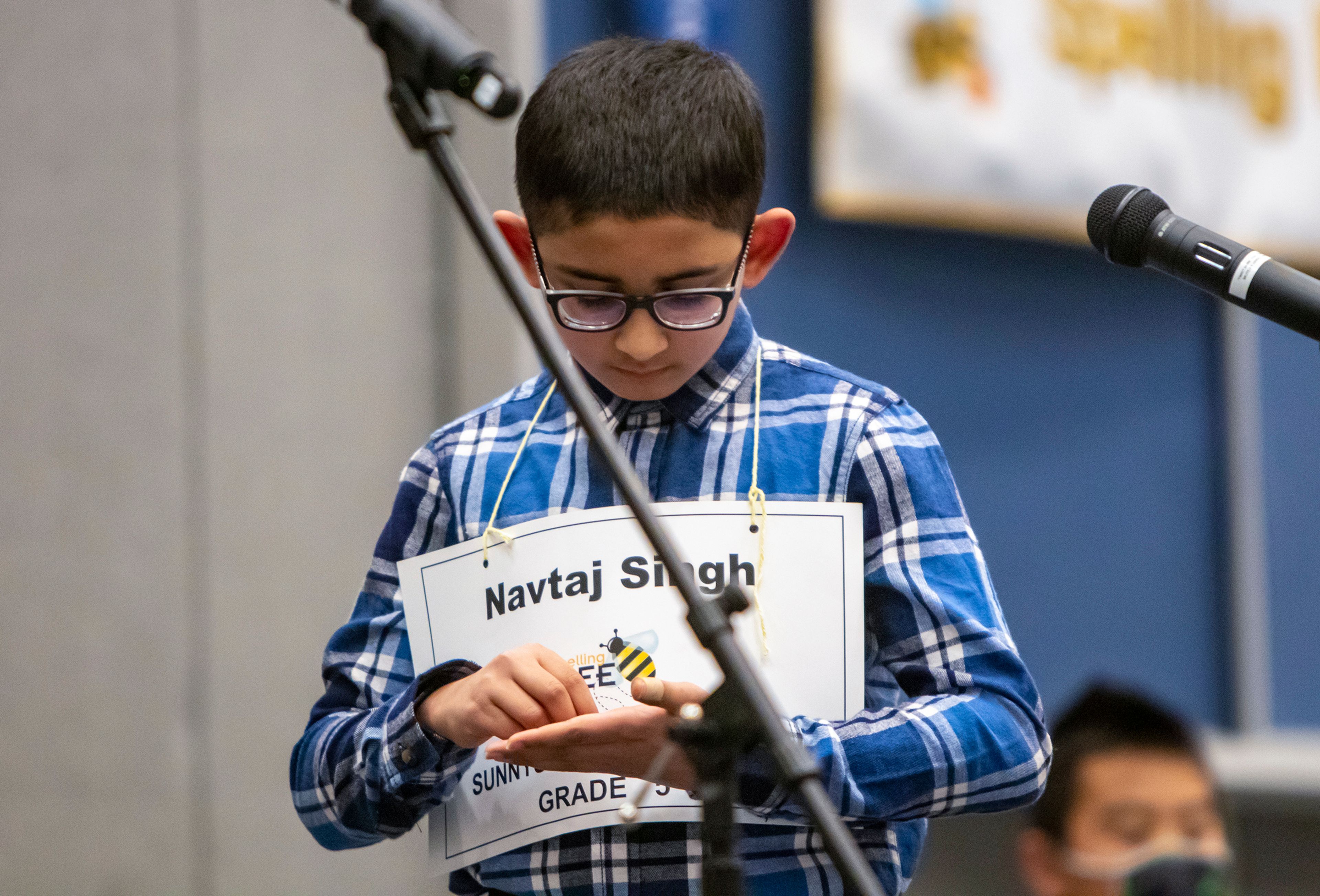 Austin Johnson/Daily News Singh spells a word out on his hand Saturday during the Inland Northwest Regional Spelling Bee.