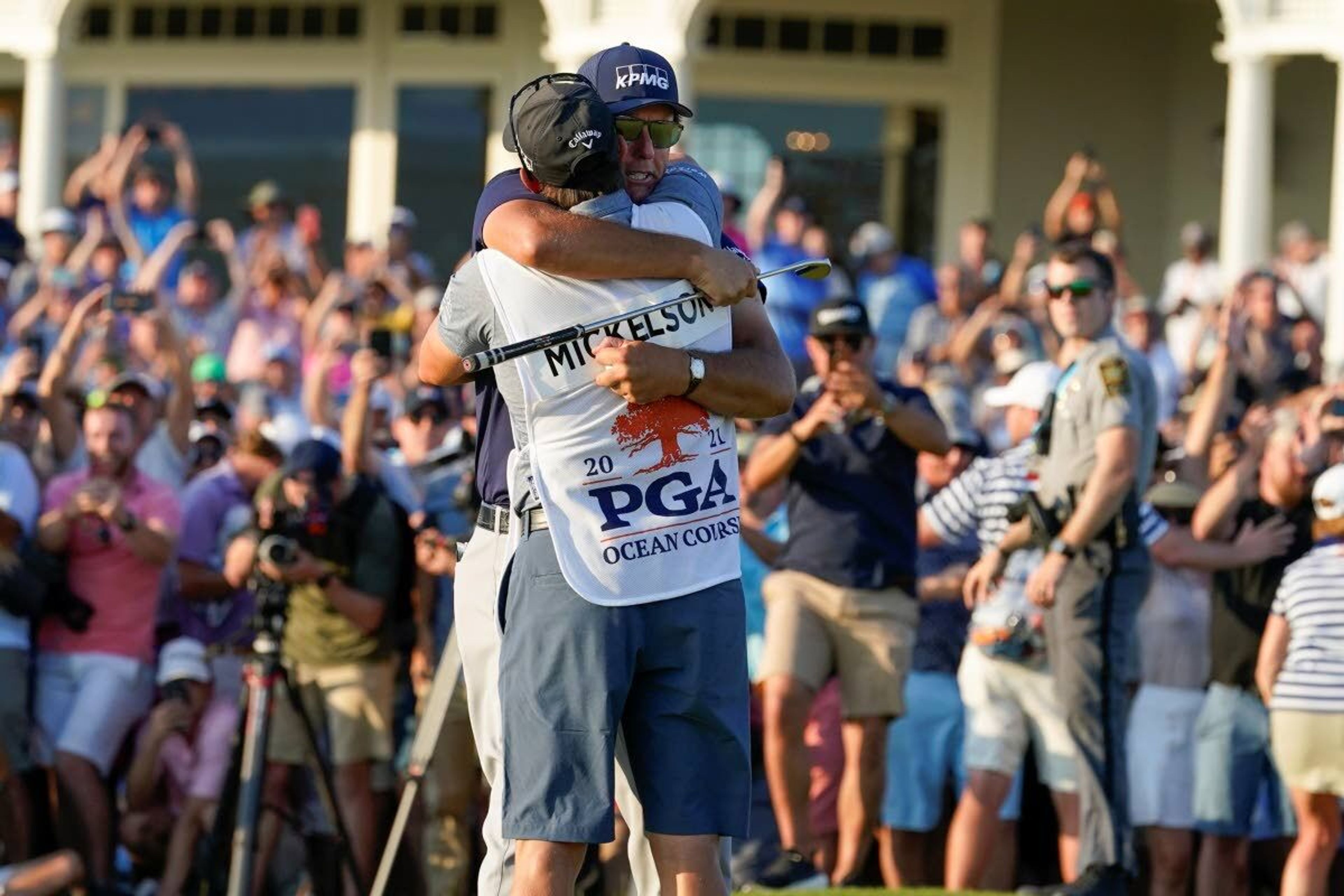 Phil Mickelson embraces his caddie after winning the final round at the PGA Championship golf tournament on the Ocean Course, Sunday, May 23, 2021, in Kiawah Island, S.C. (AP Photo/Matt York)