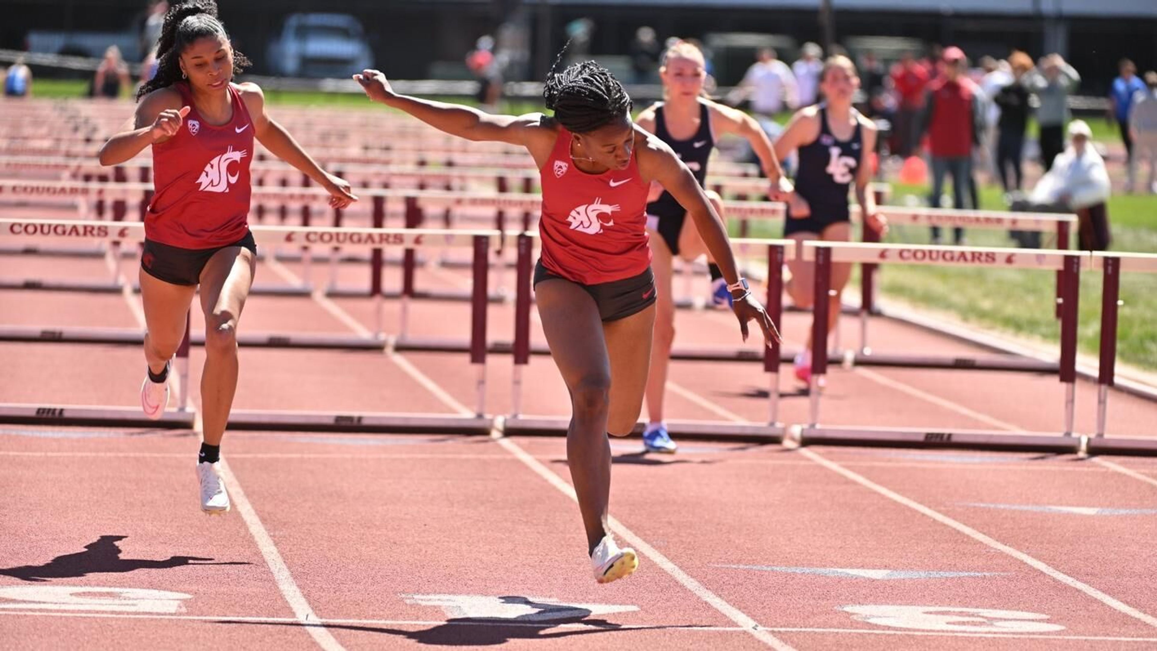 Washington State hurdler Maribel Caicedo, center, crosses the finish line in a first-place, program-record time of 12.85 seconds in the women's 100-meter hurdles recently at Mooberry Track in Pullman.