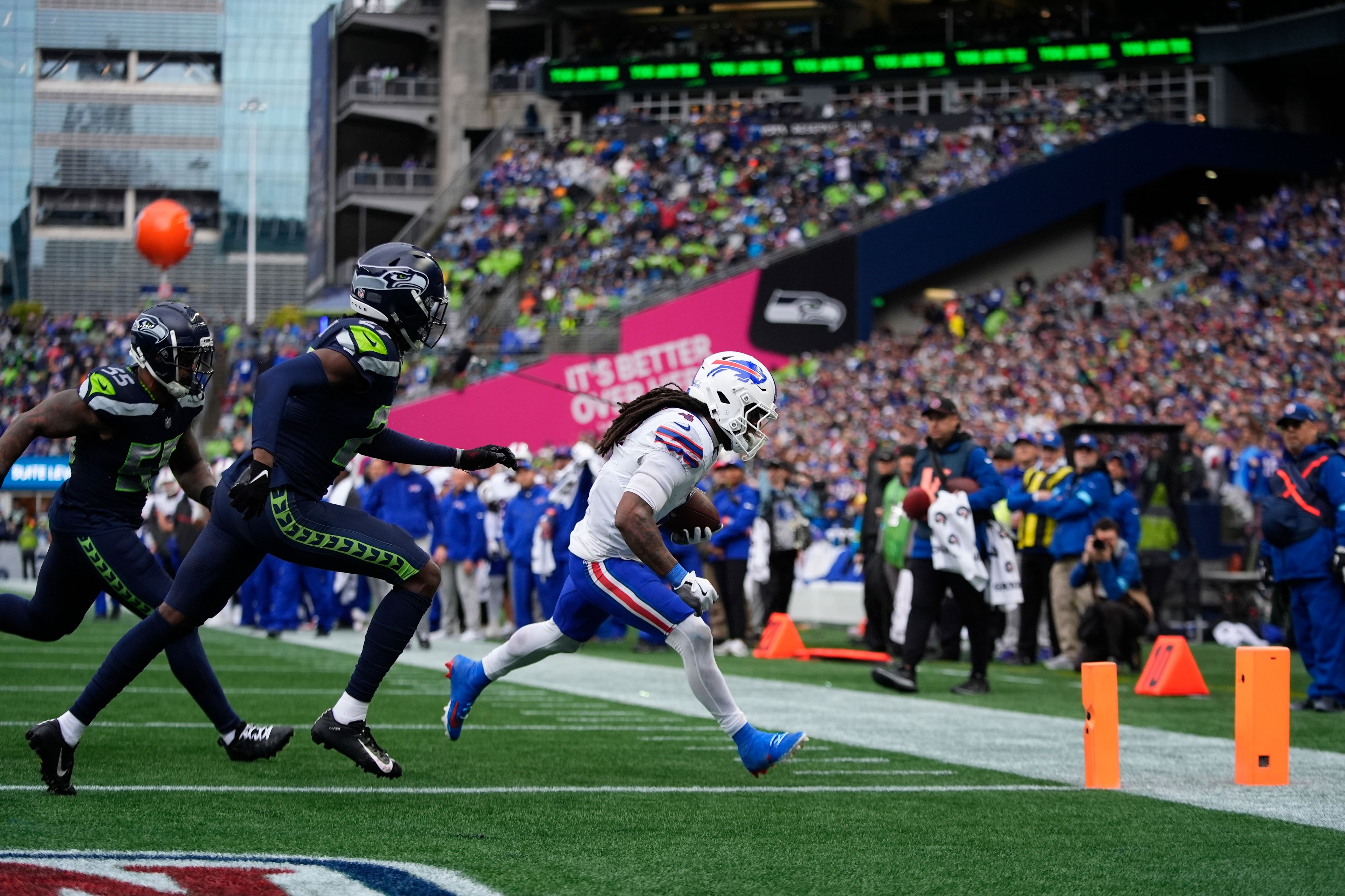 Buffalo Bills running back James Cook (4) runs for a touchdown against Seattle Seahawks cornerback Riq Woolen, center, and defensive end Dre'Mont Jones (55) during the second half Sunday in Seattle.