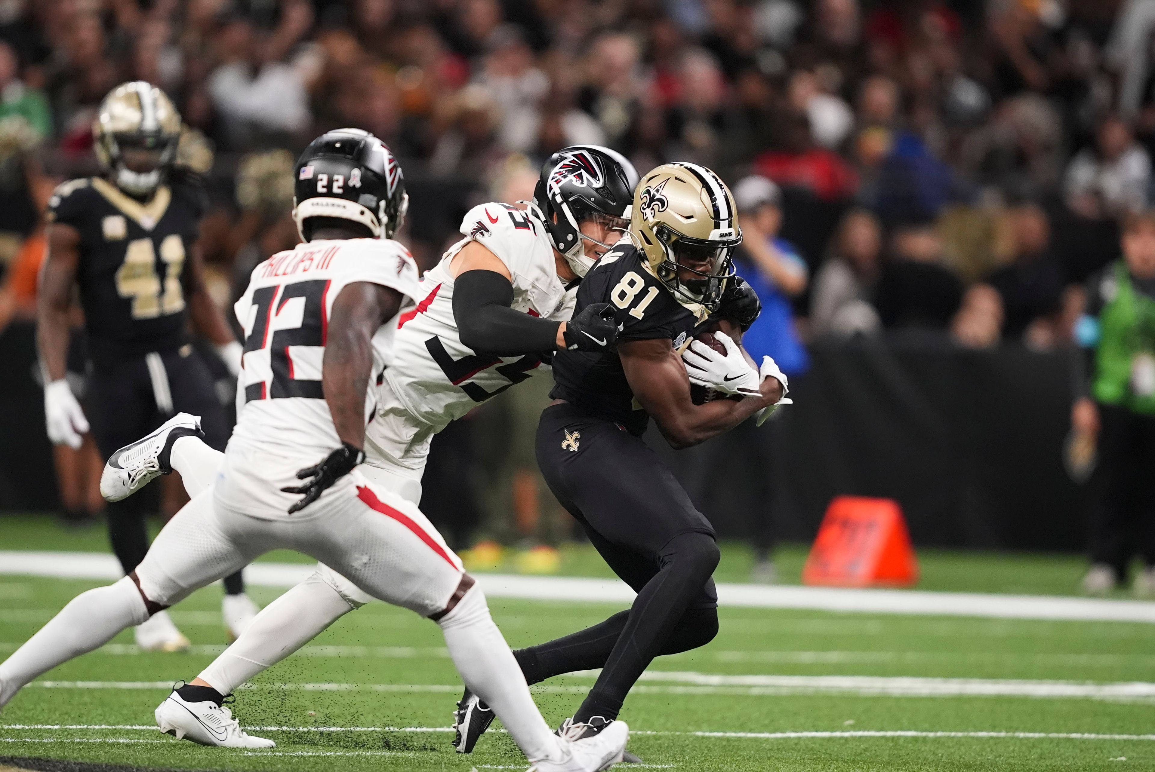 New Orleans Saints wide receiver Kevin Austin Jr. (81) Carris against Atlanta Falcons linebacker Kaden Elliss (55) and cornerback Clark Phillips III (22) in the second half of an NFL football game in New Orleans, Sunday, Nov. 10, 2024. (AP Photo/Gerald Herbert)